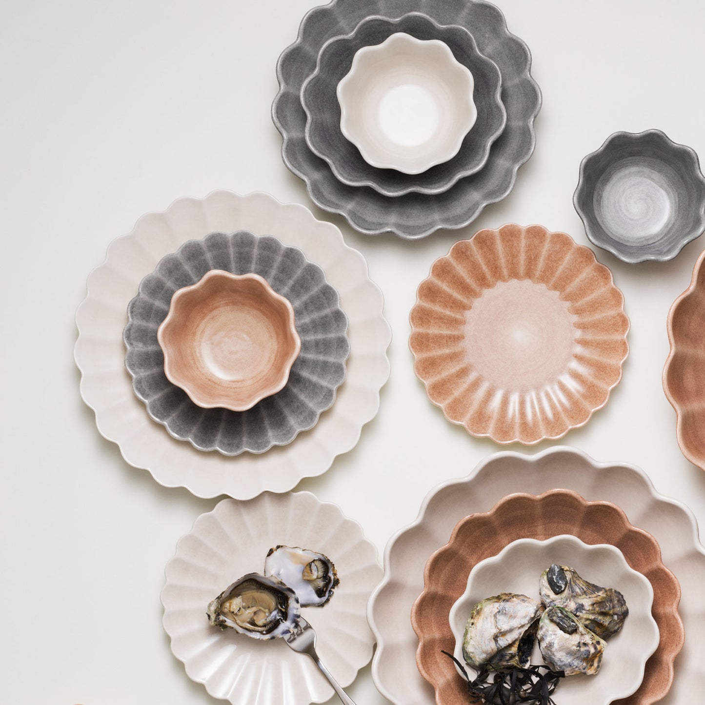 Set of ceramic bowls in various colors on a light background