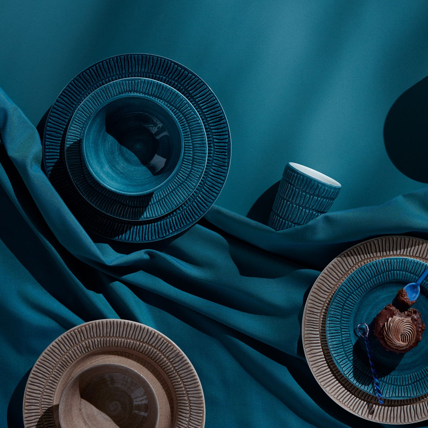 Decorative bowls on a teal fabric background