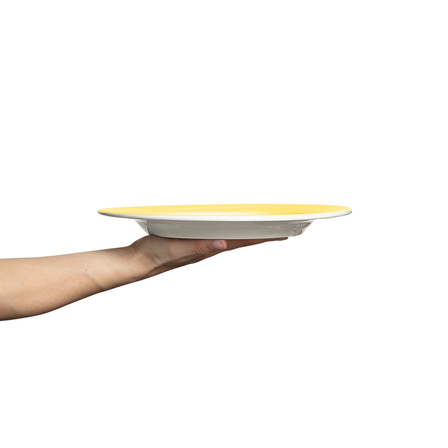 Hand holding a yellow and white ceramic plate against a white background