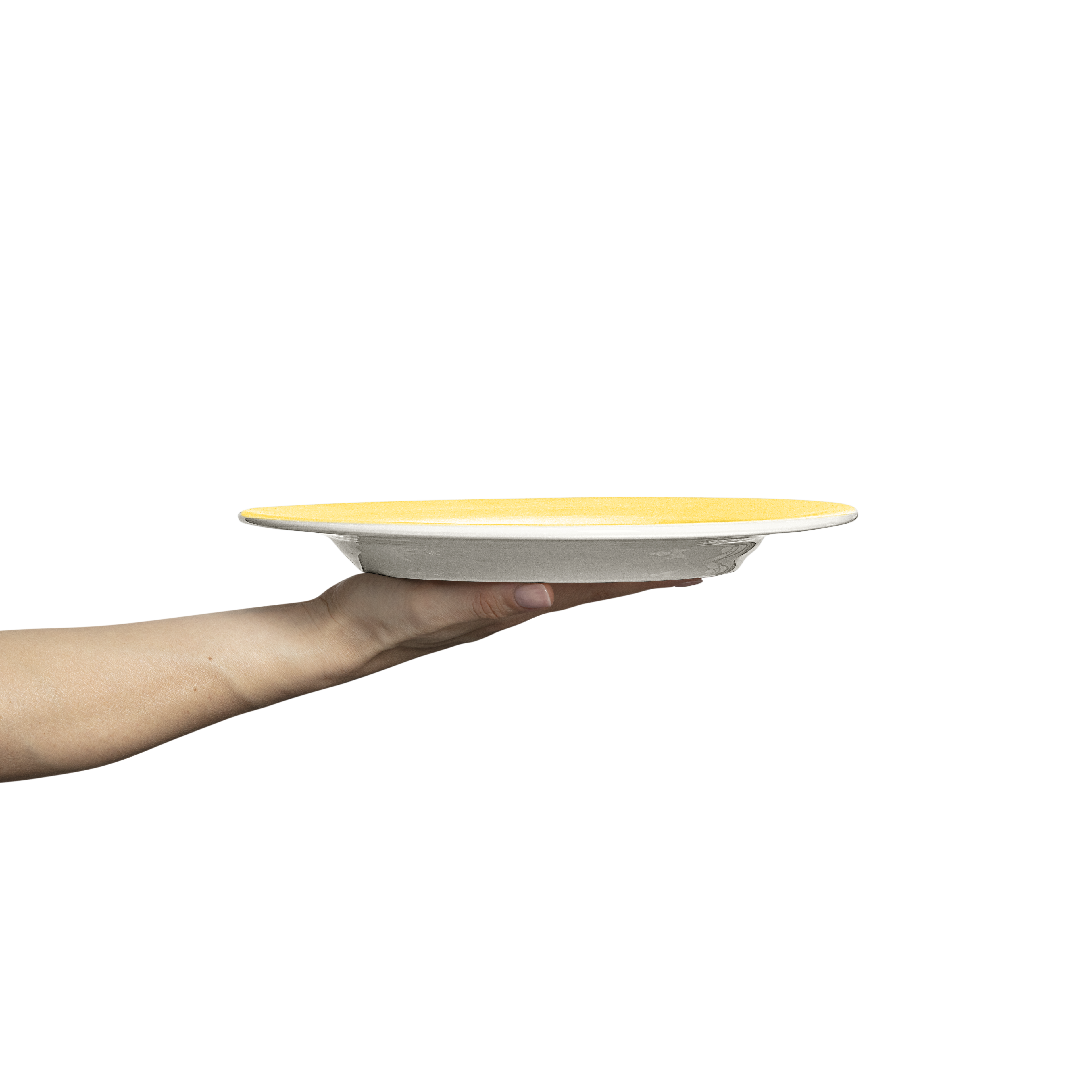 Hand holding a yellow and white ceramic plate against a white background