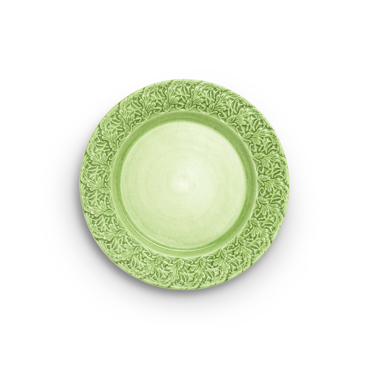 Green decorative plate with intricate patterns on a white background