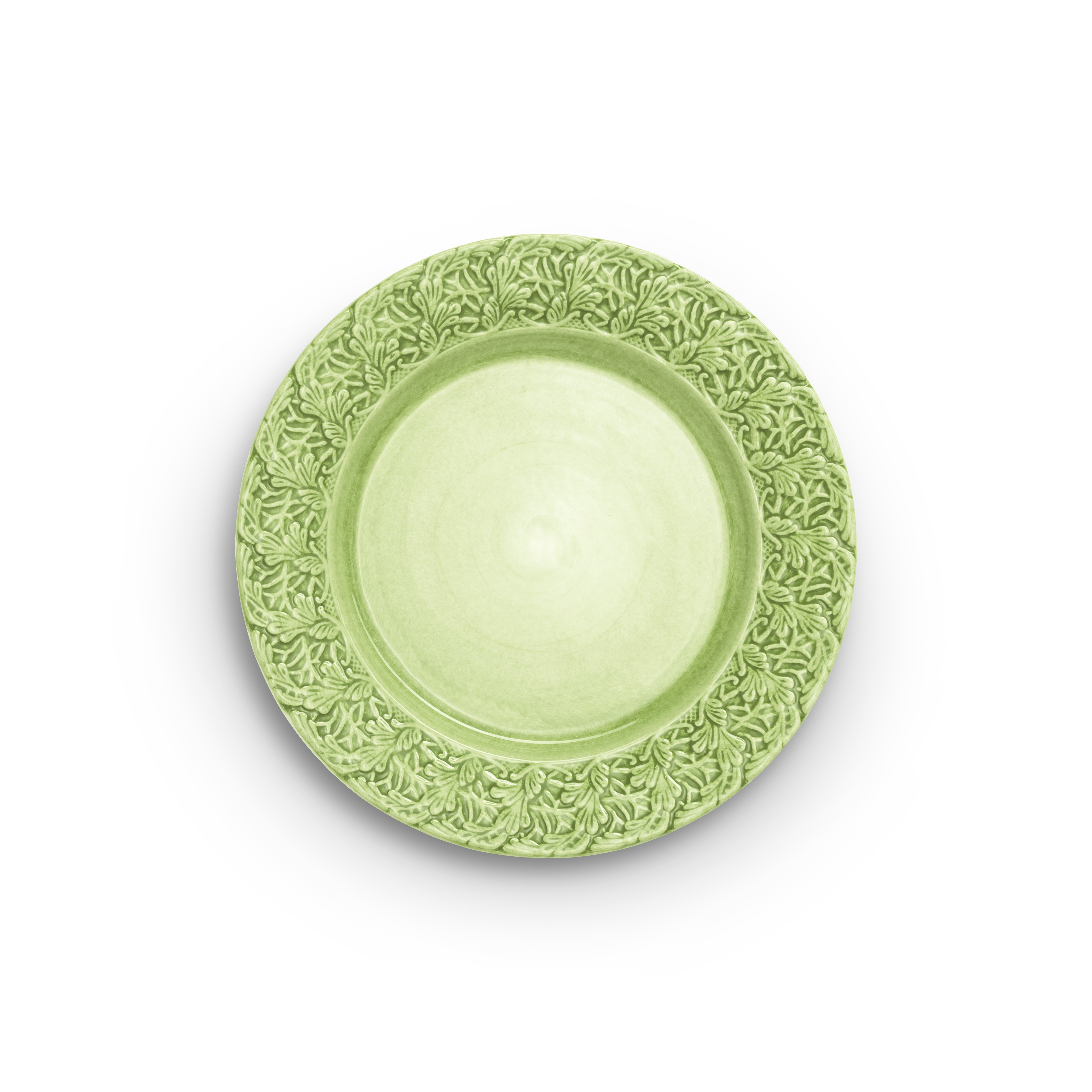 Green decorative plate with intricate patterns on a white background