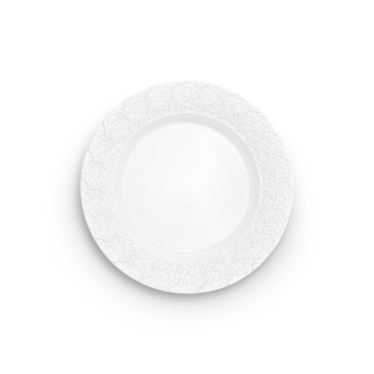Decorative white plate with intricate lace pattern on a white background