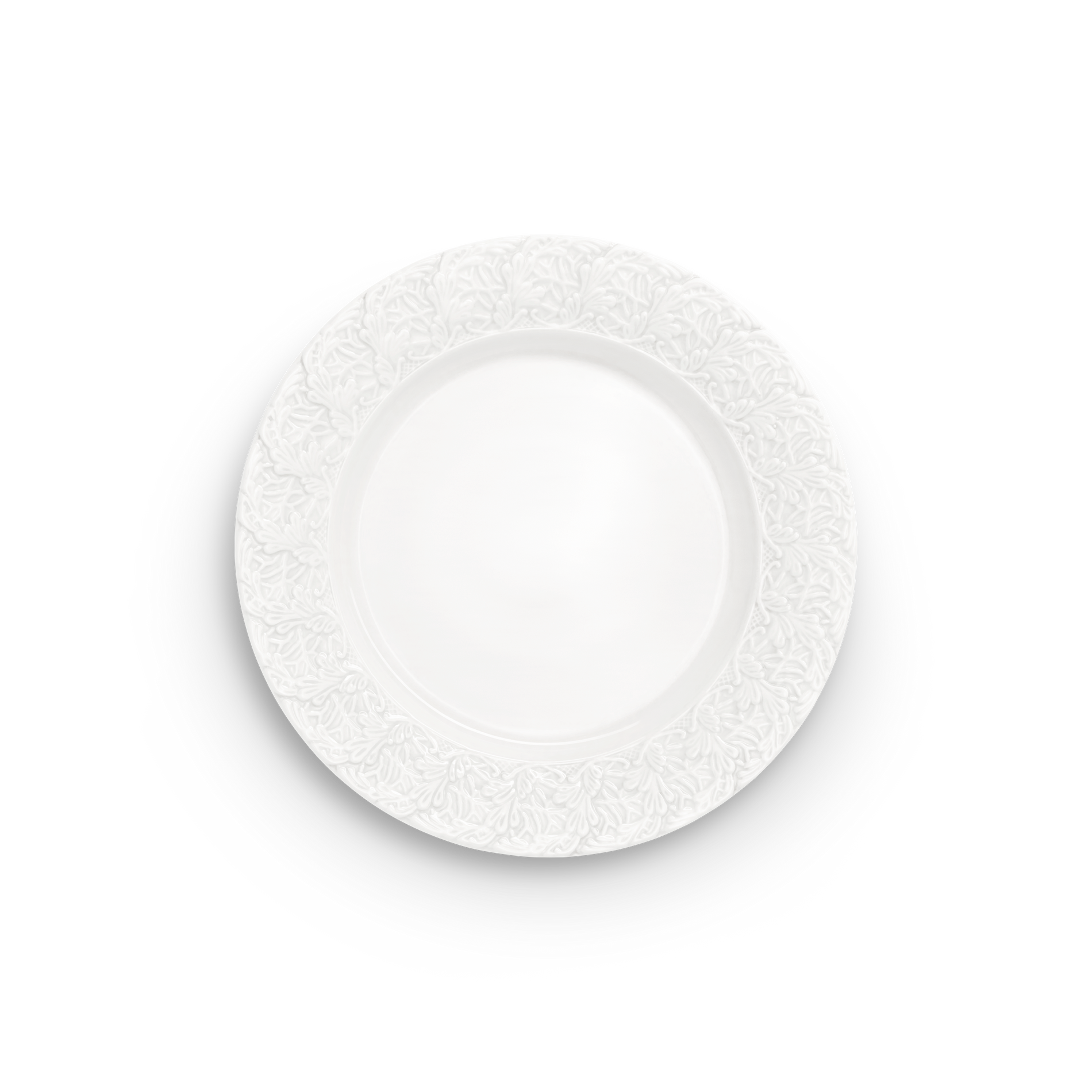 Decorative white plate with intricate lace pattern on a white background