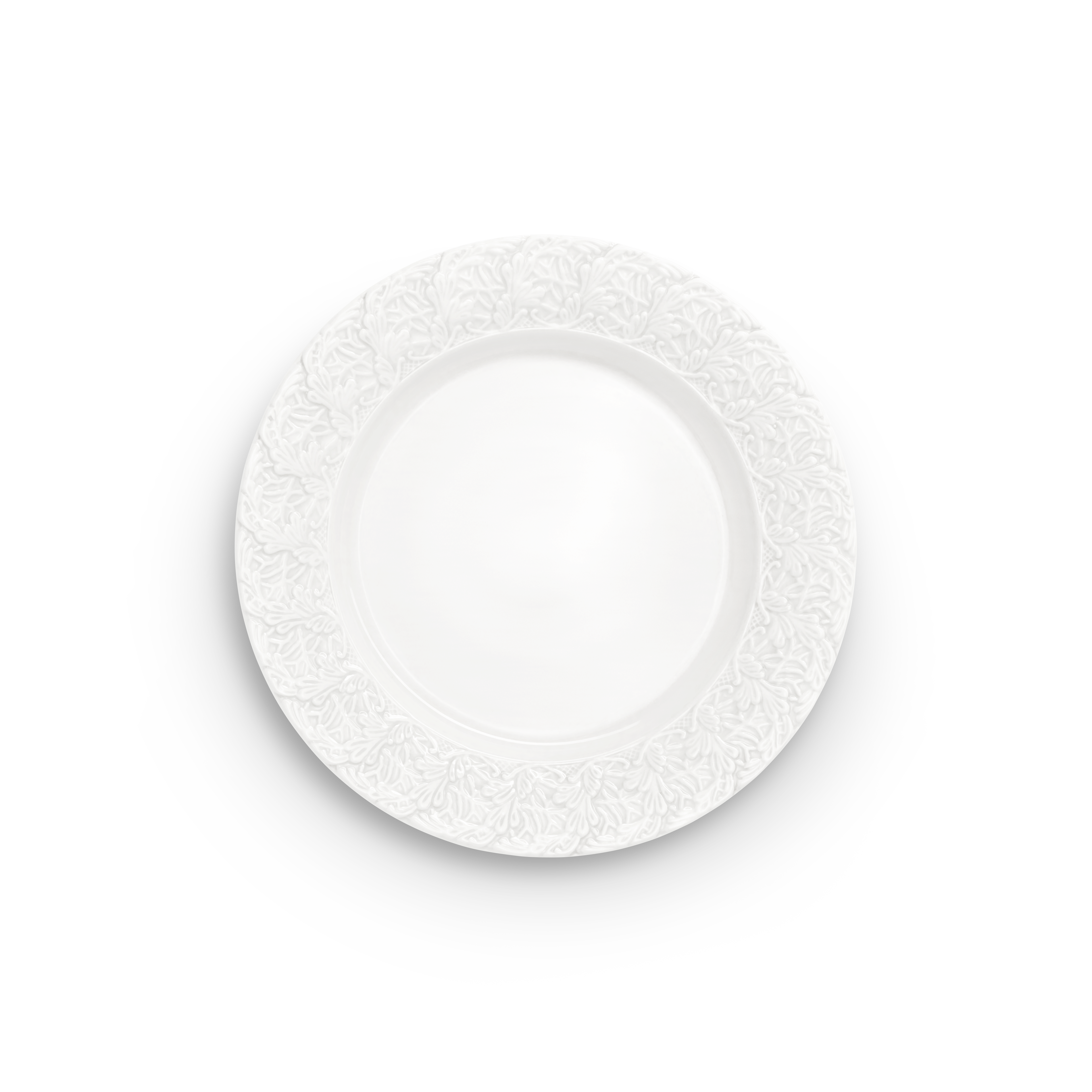 Decorative white plate with intricate lace pattern on a white background