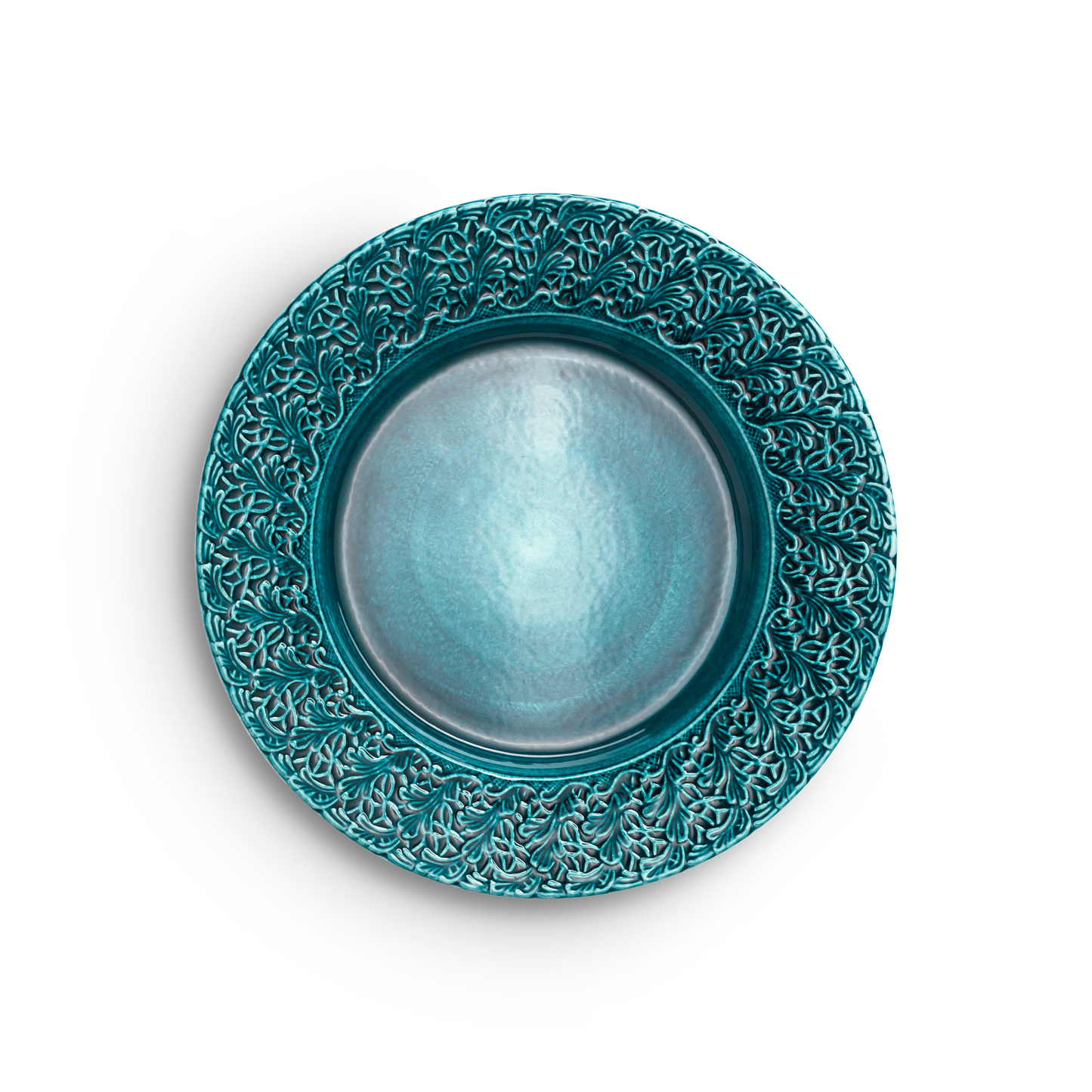 Teal ceramic plate with intricate patterns on a white background