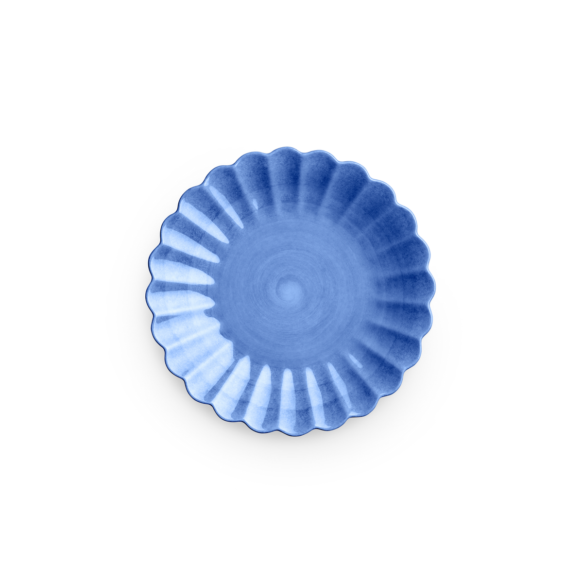 Blue ceramic dish with a scalloped edge on a white background