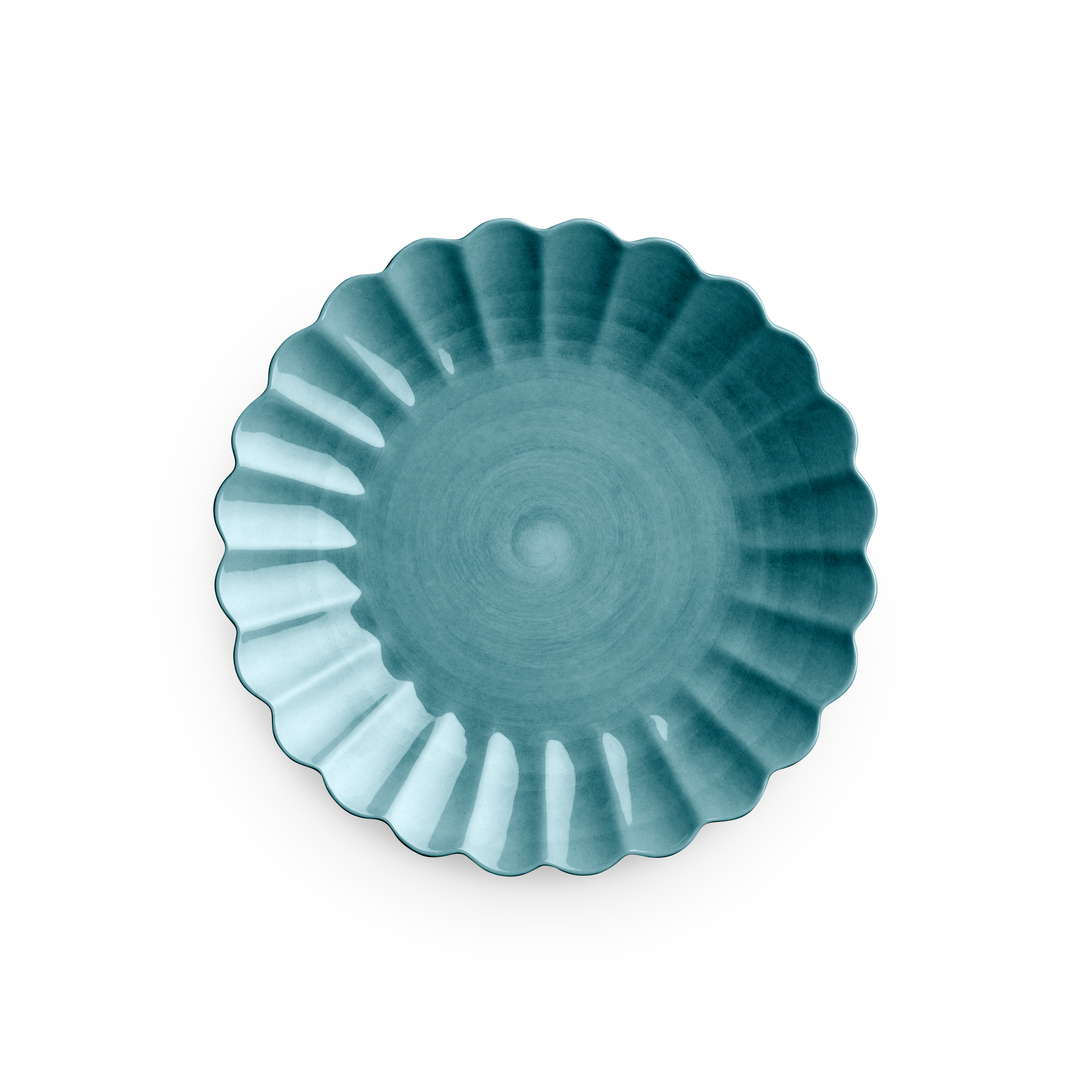 Teal ceramic plate with decorative edge on a white background