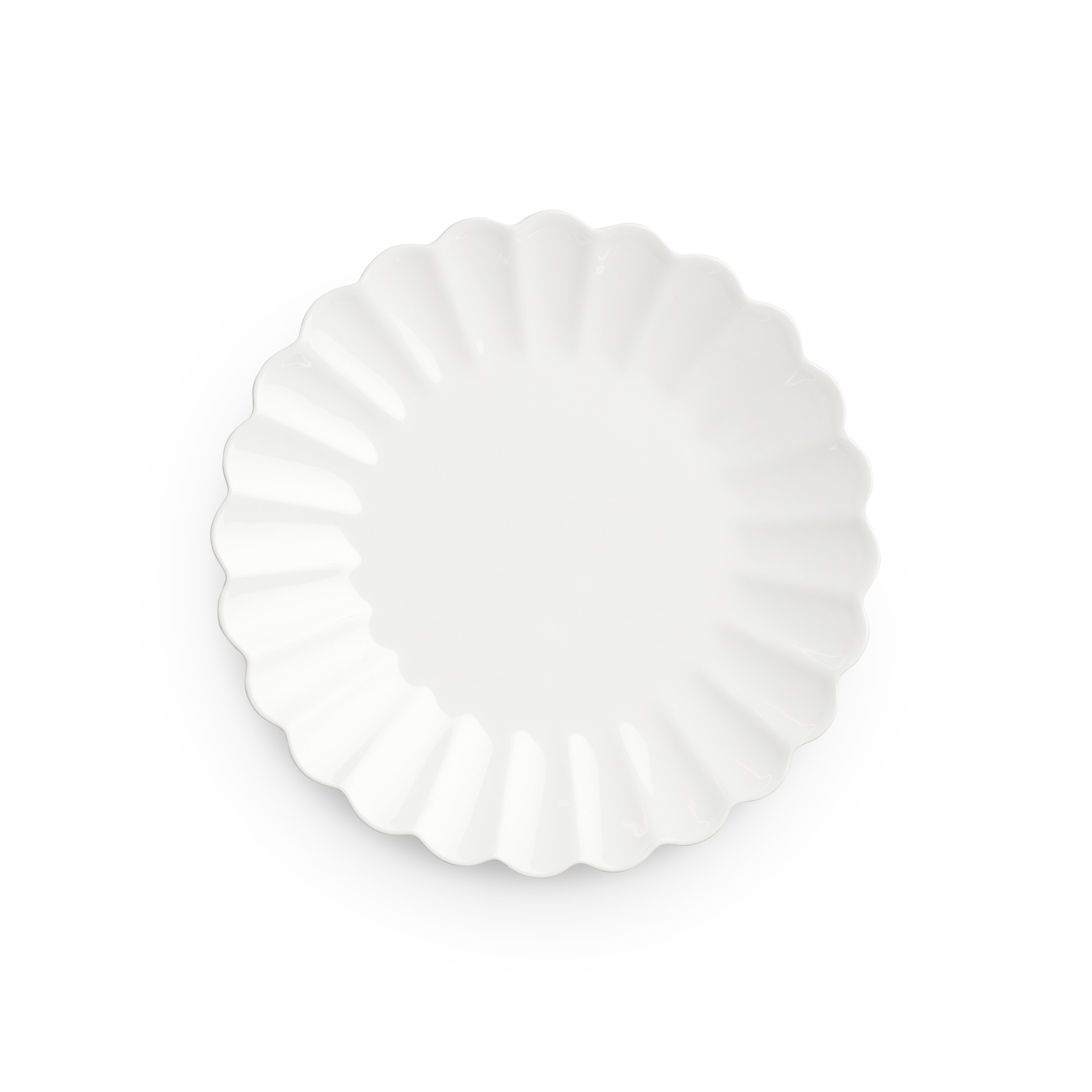 Decorative white plate with scalloped edge on a white background