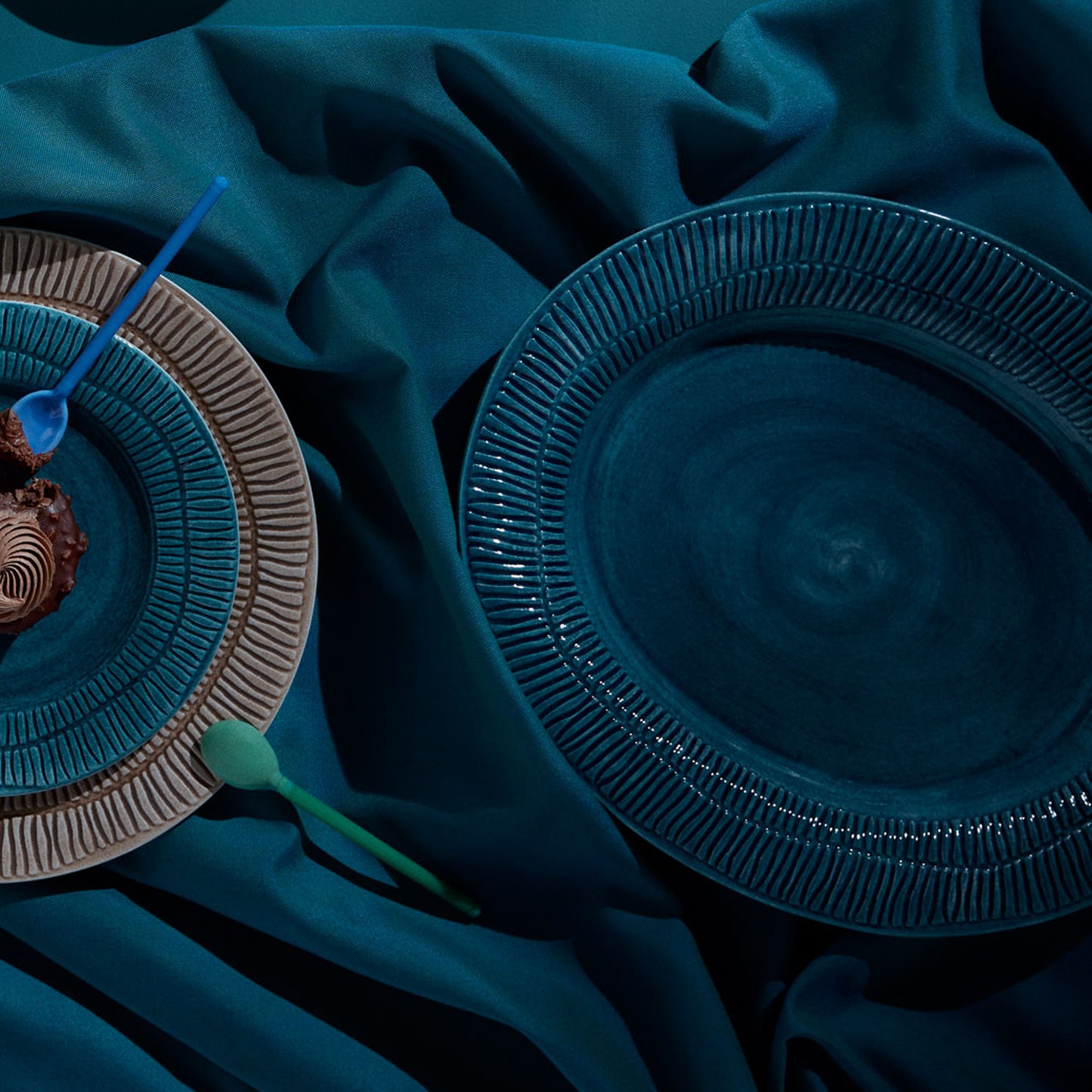 Blue ceramic plates on a dark blue fabric background