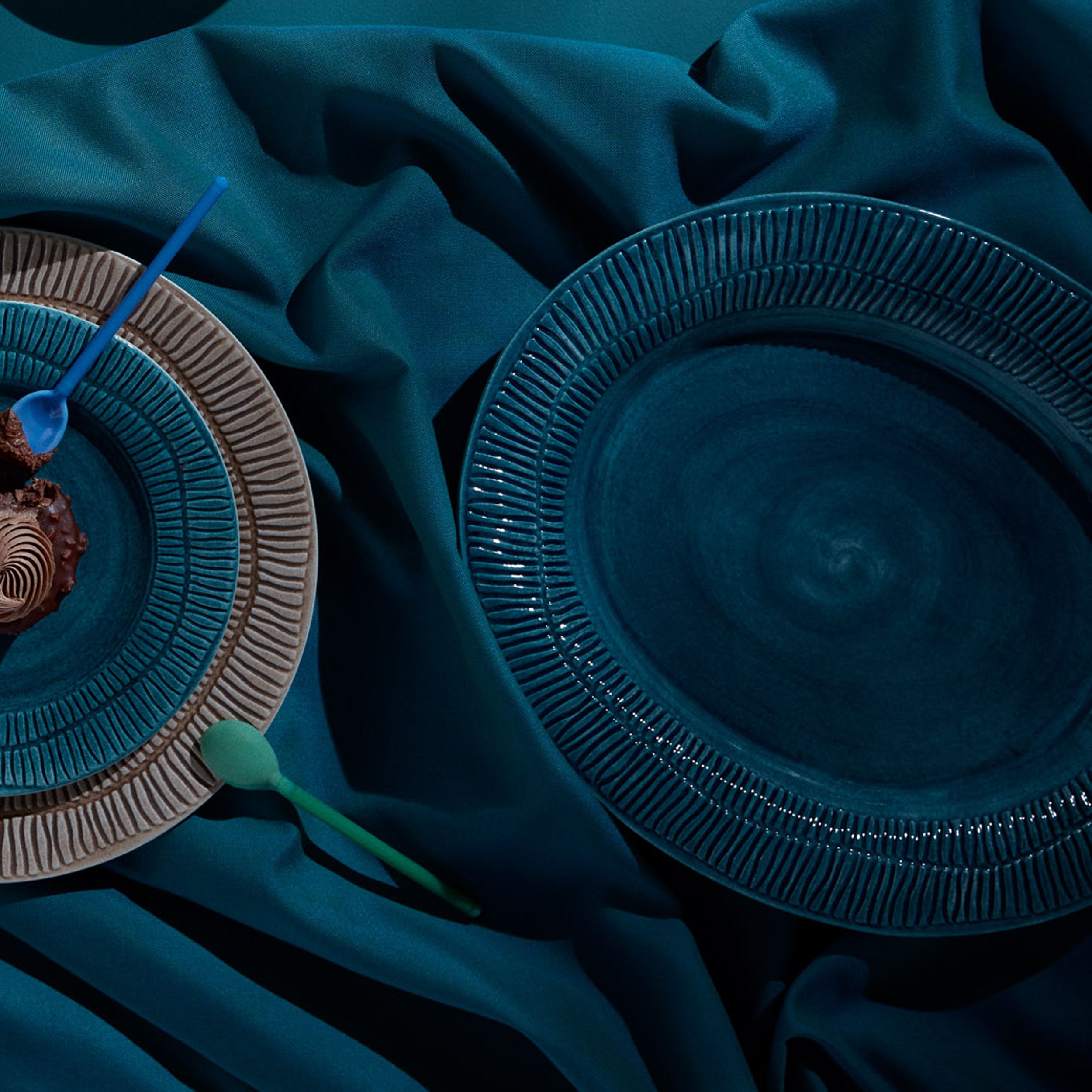 Blue ceramic plates on a dark blue fabric background