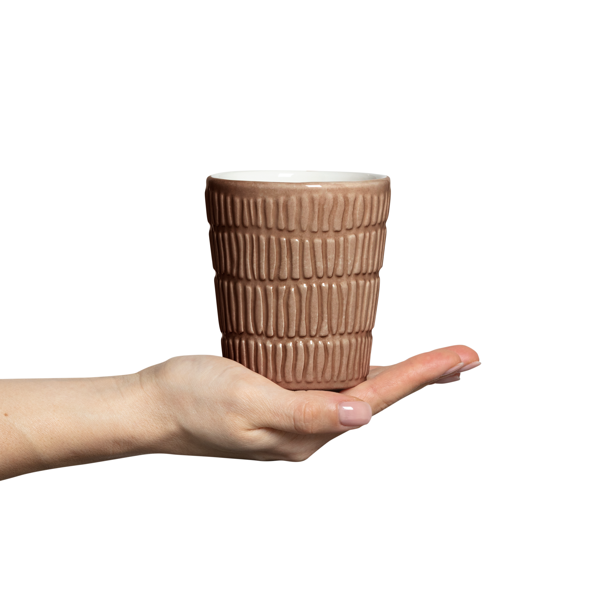 Hand holding a textured ceramic mug on a white background