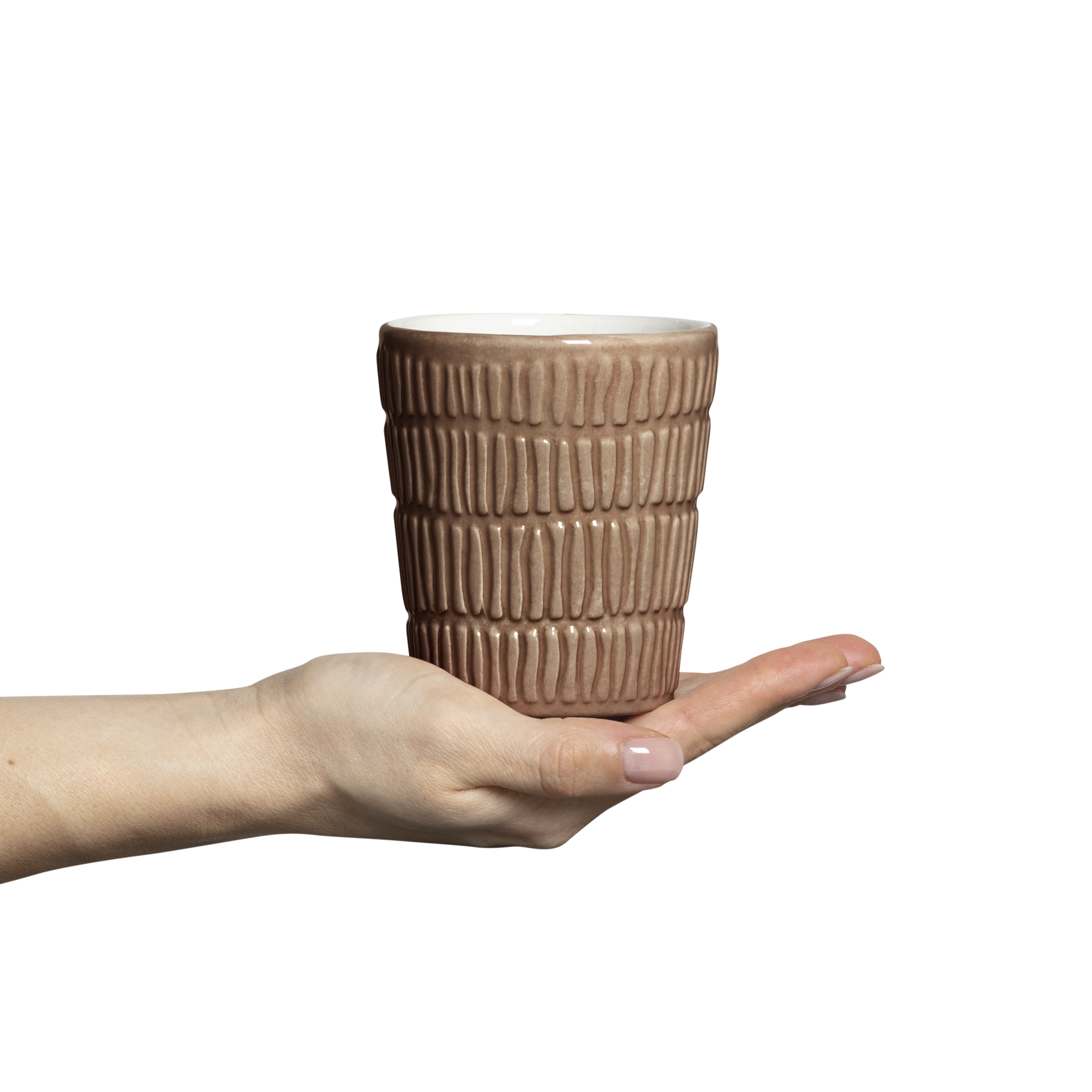 Hand holding a textured ceramic mug on a white background