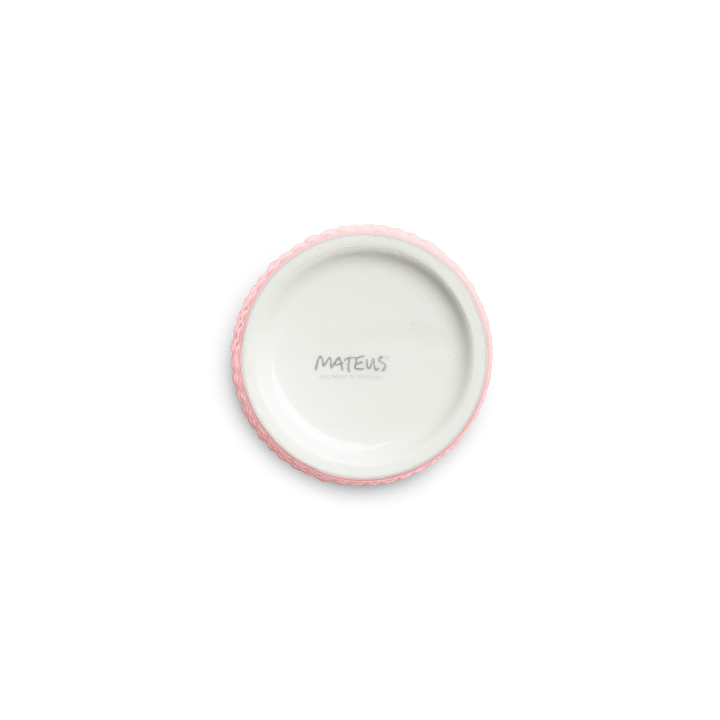 Pink textured ceramic cup bottom against a white background