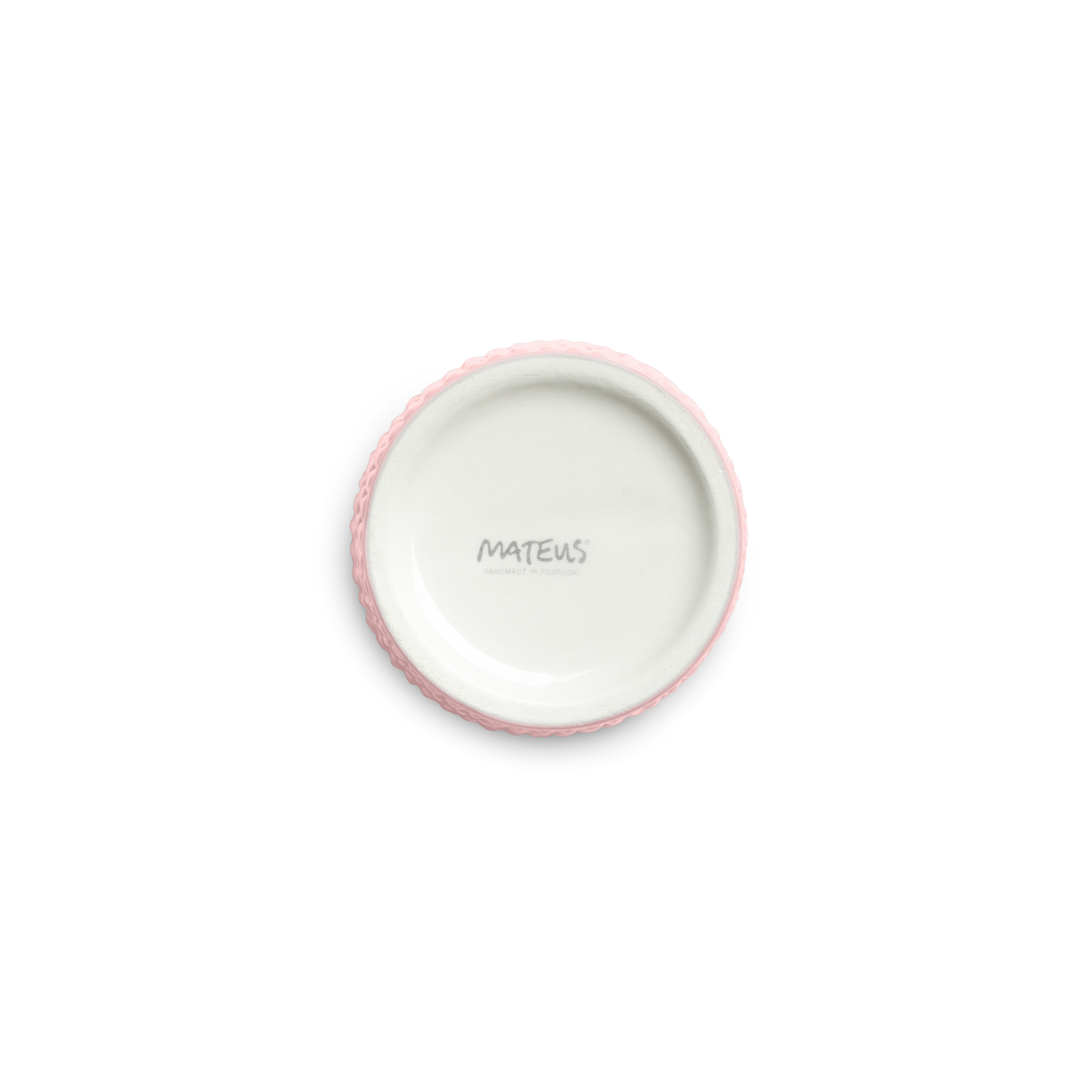 Pink textured ceramic cup bottom against a white background