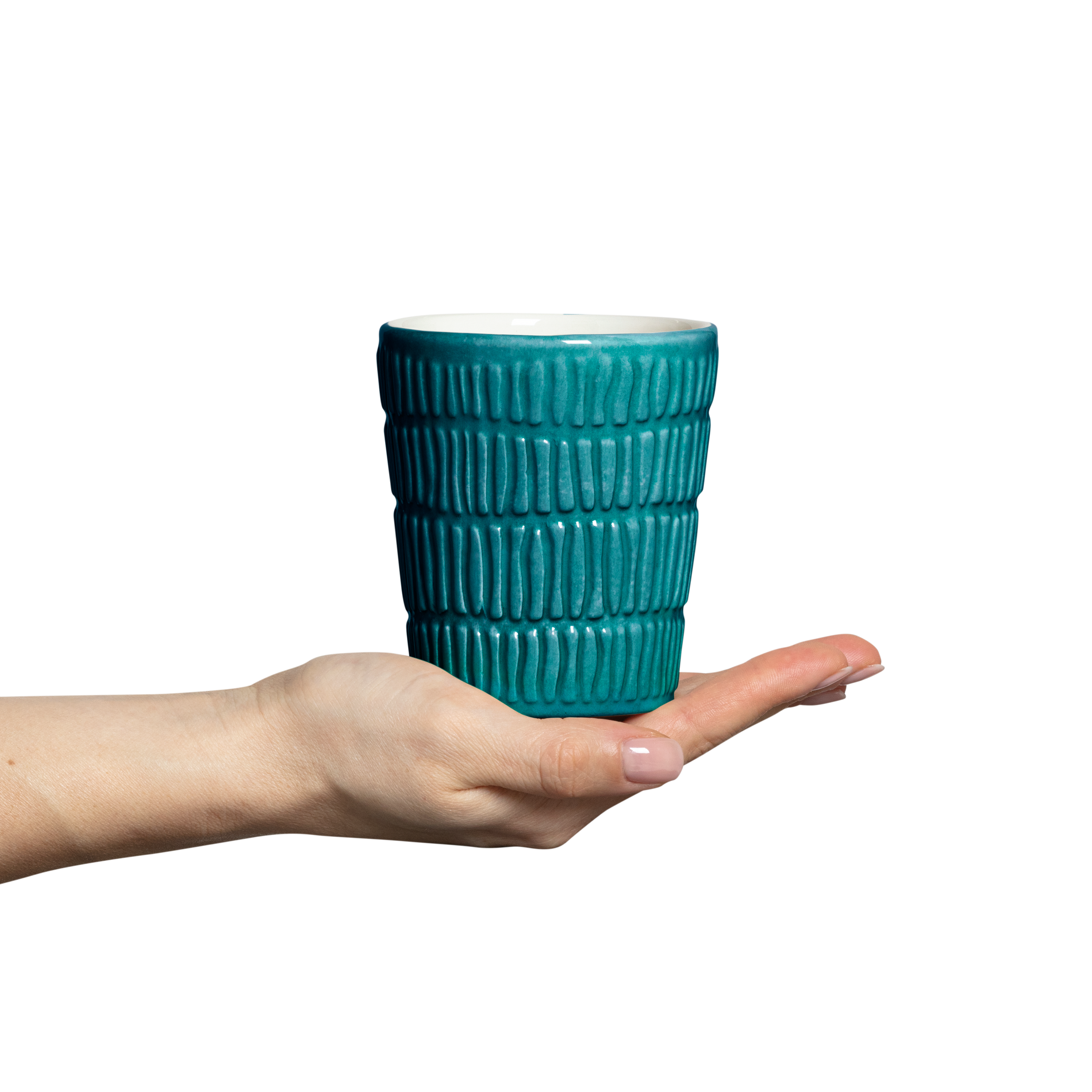 Teal textured mug held in a hand against a white background
