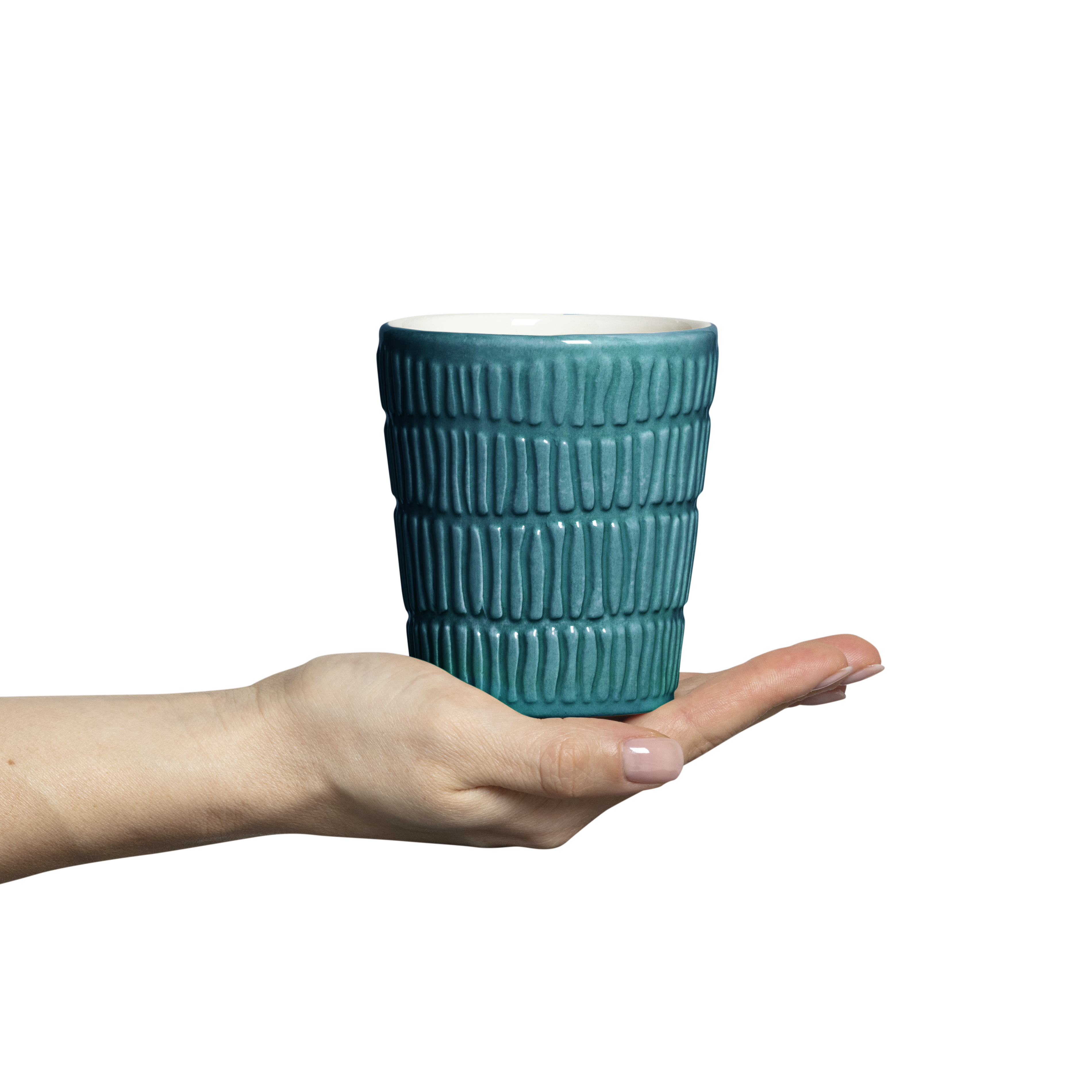Teal textured mug held in a hand against a white background