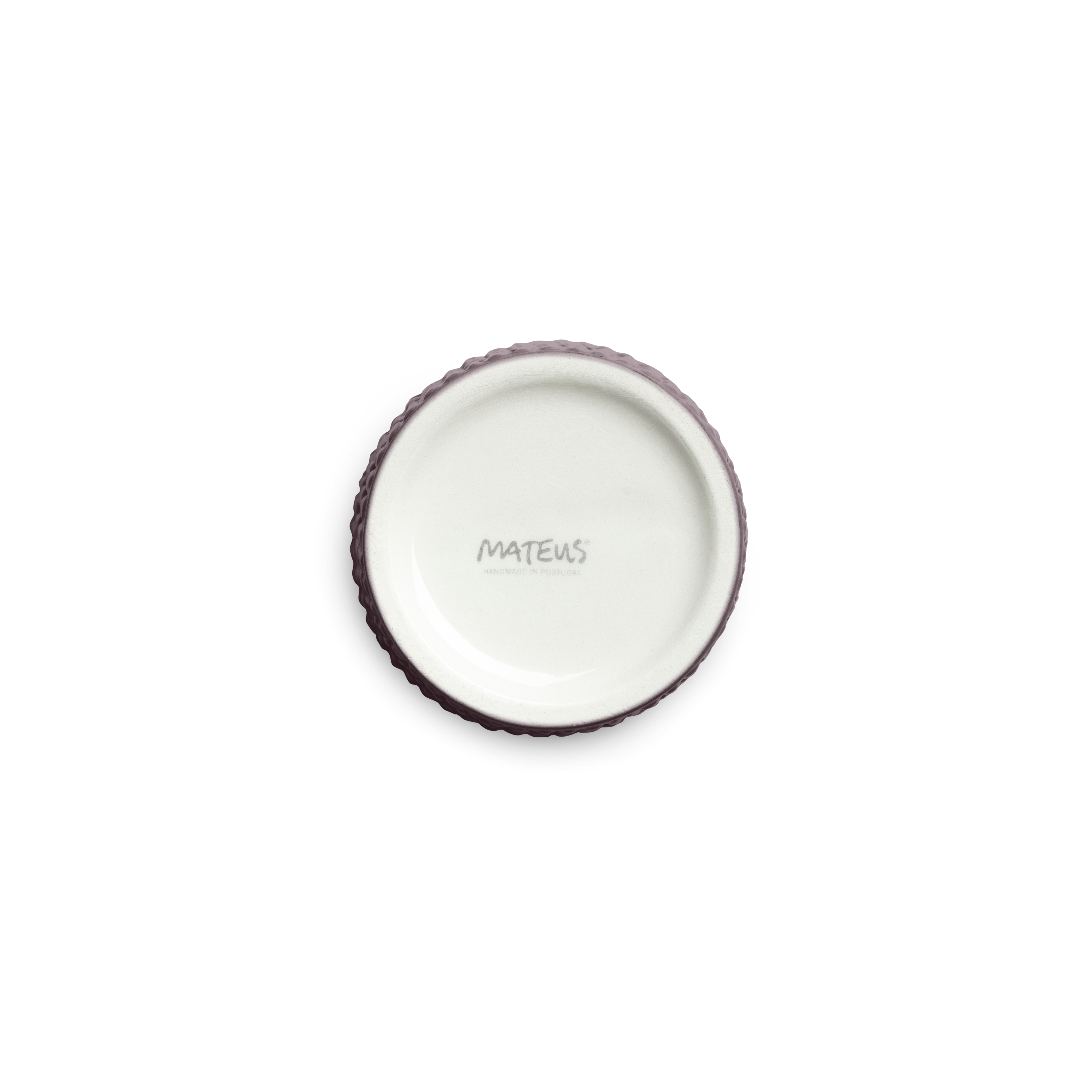 textured ceramic cup bottom against a white background