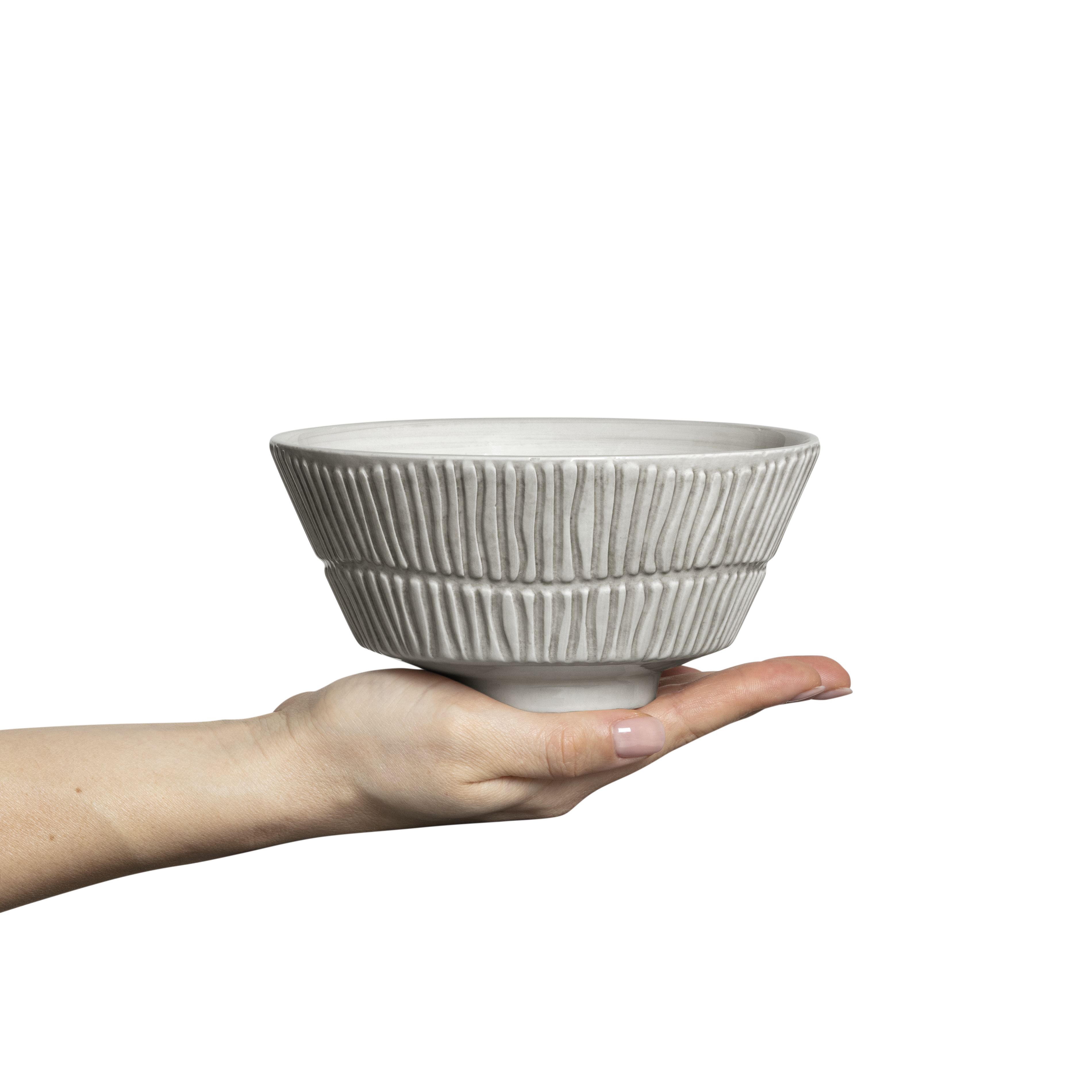 Hand holding a textured ceramic bowl against a white background