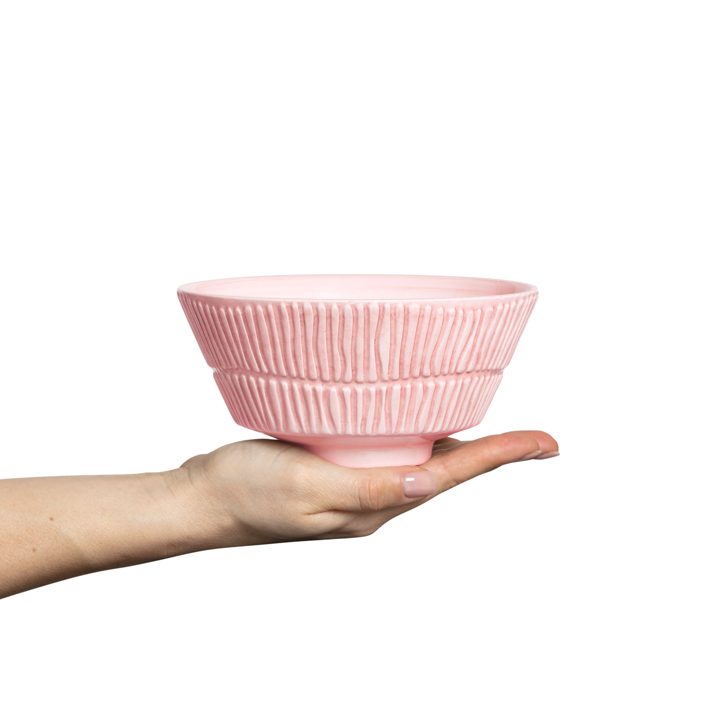 Pink ceramic bowl held in a hand against a white background