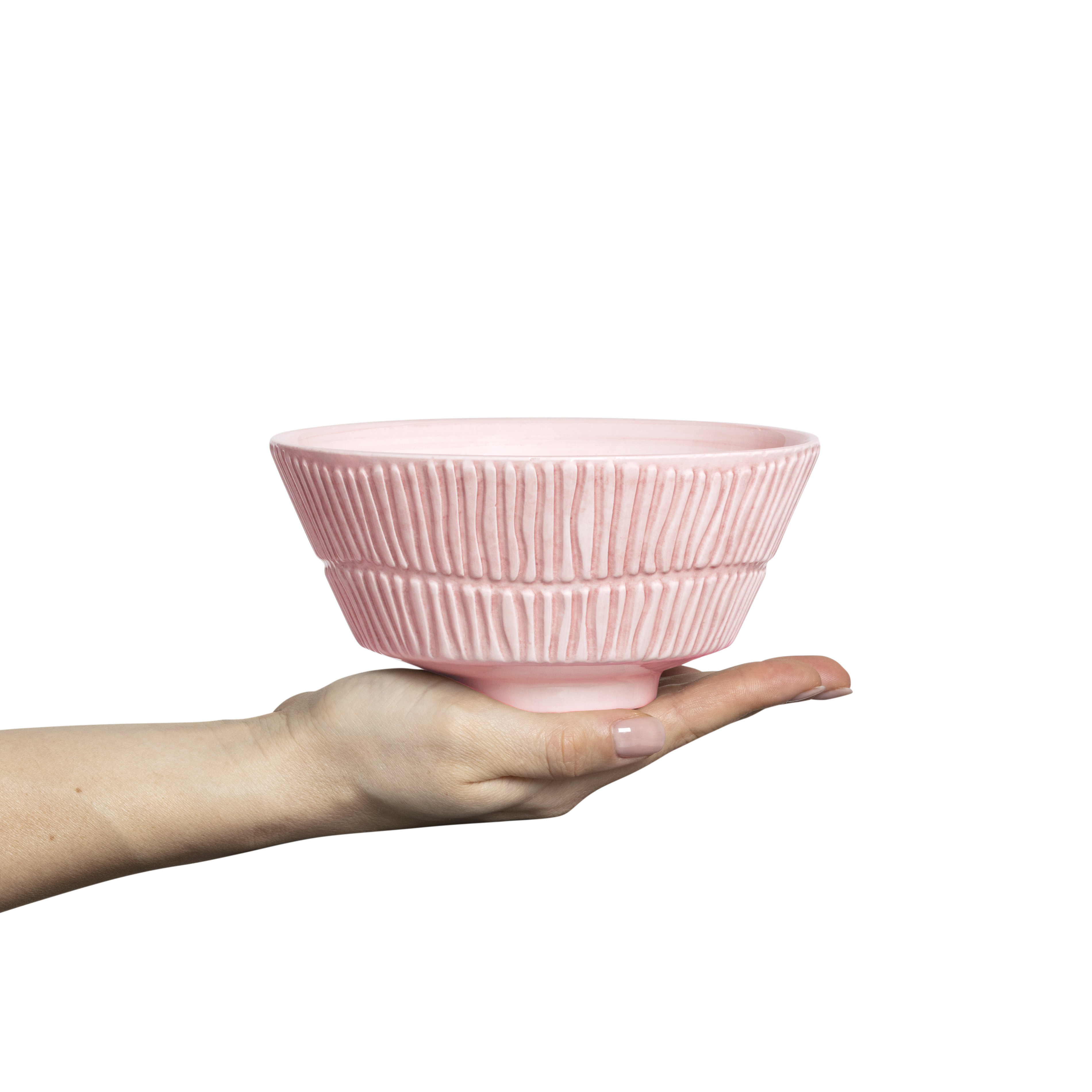 Pink ceramic bowl held in a hand against a white background