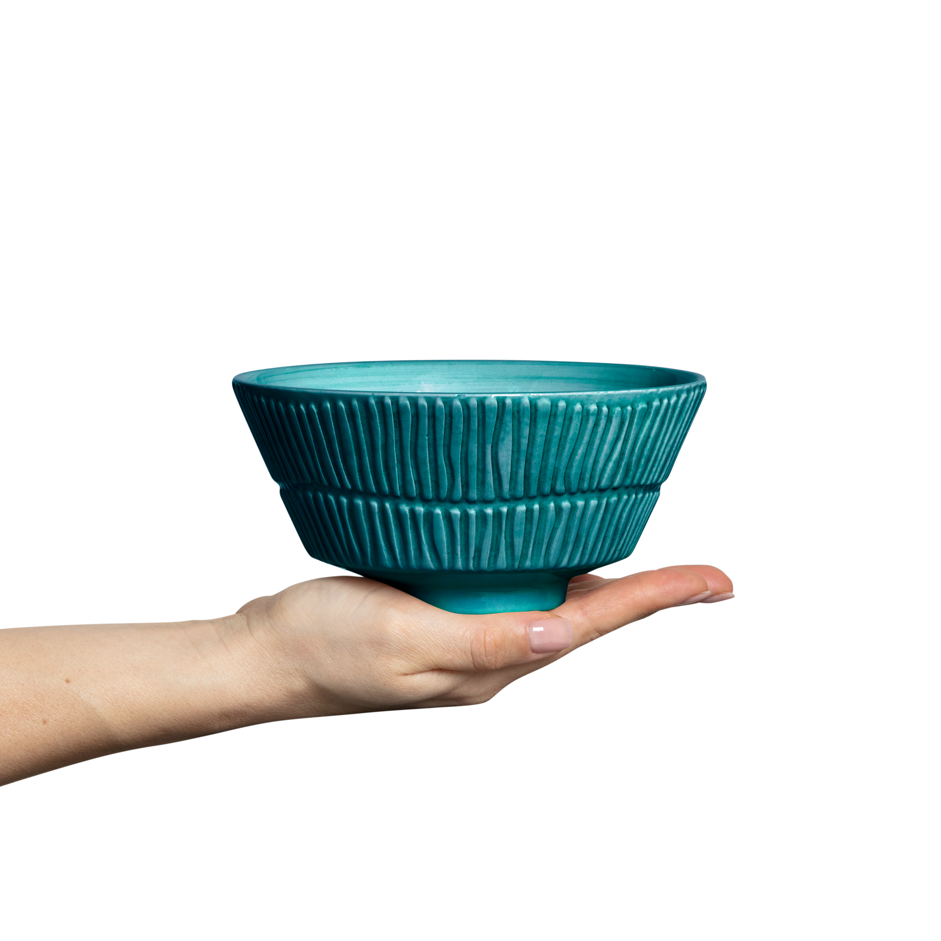 Teal ceramic bowl held in a hand against a white background