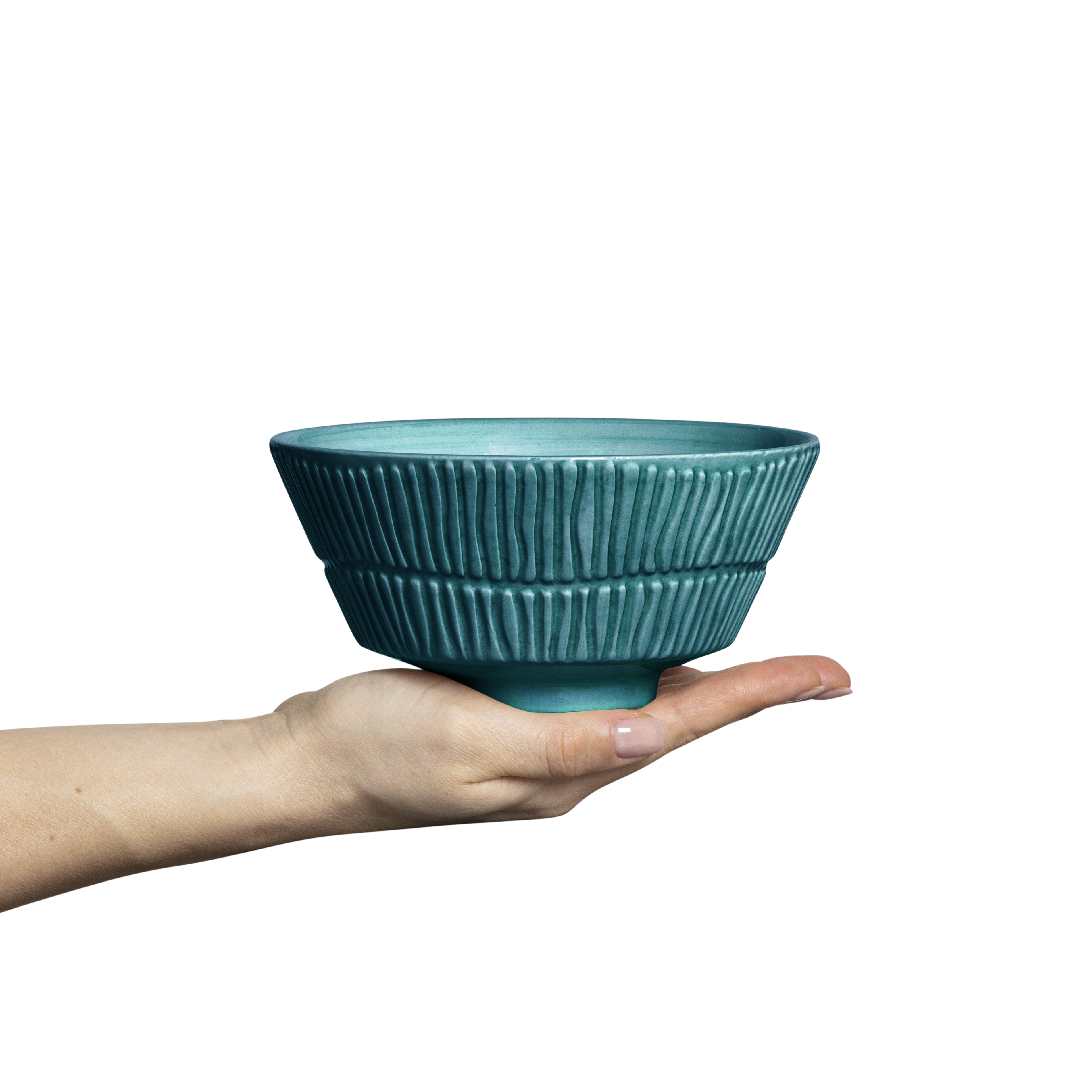 Teal ceramic bowl held in a hand against a white background