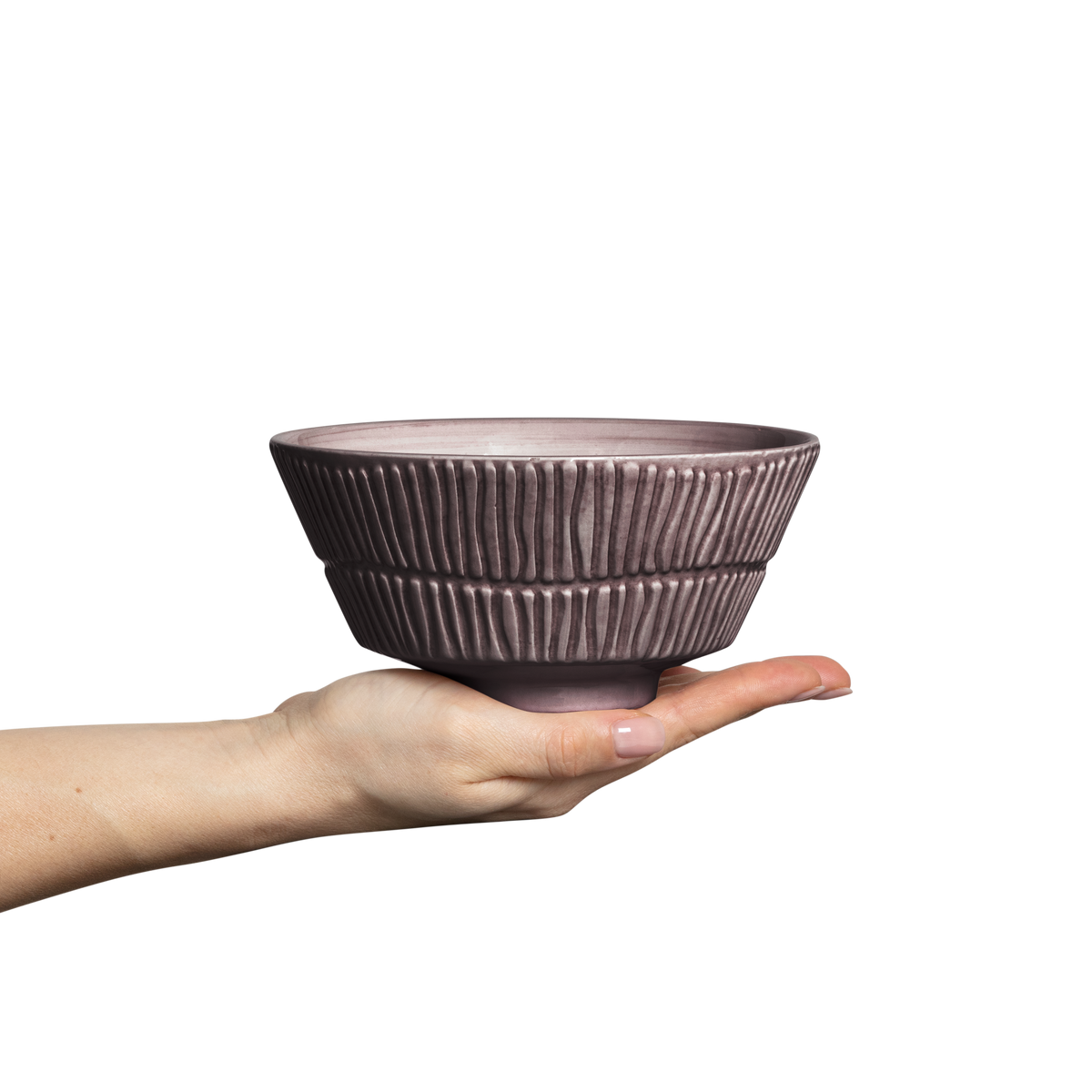 Hand holding a textured ceramic bowl against a white background