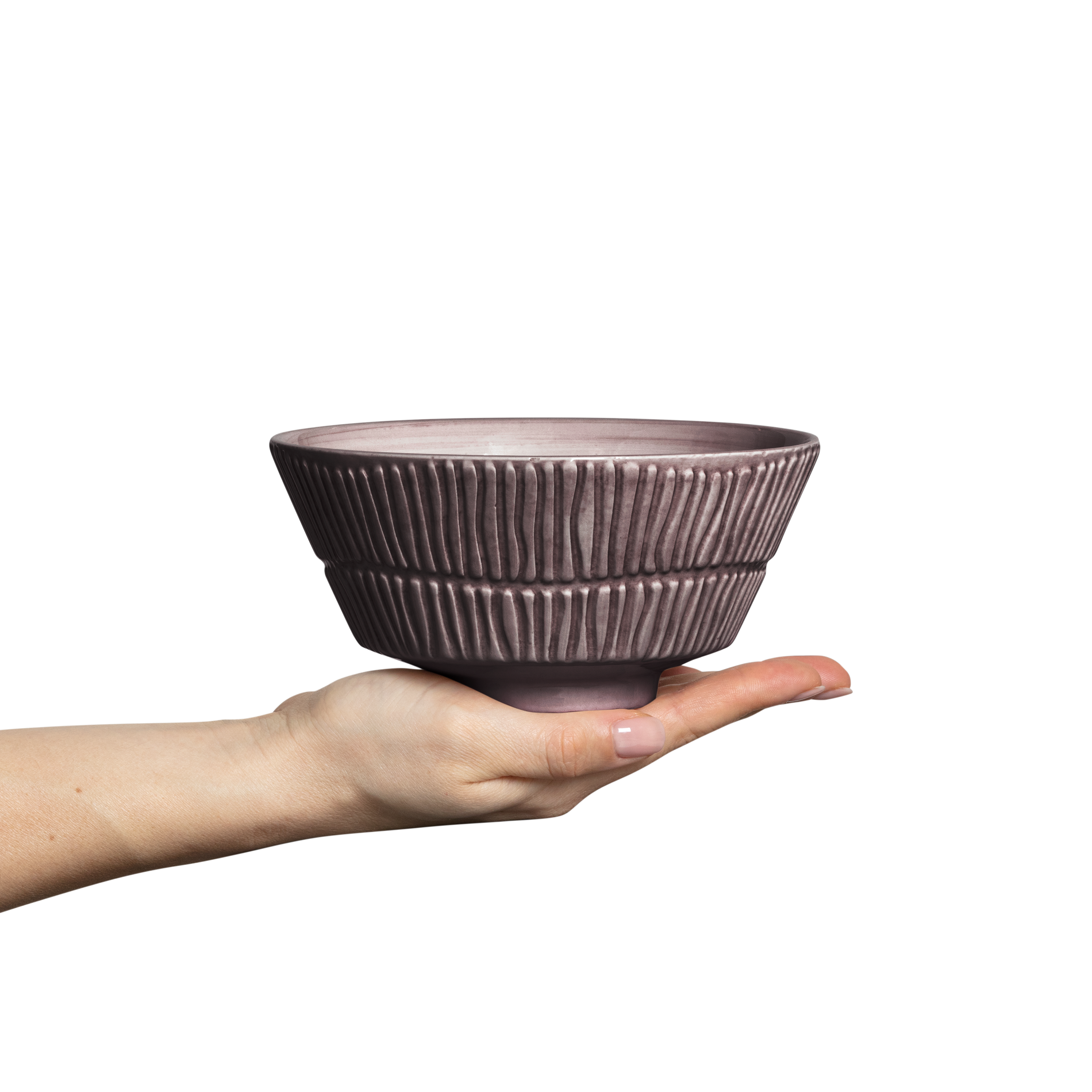 Hand holding a textured ceramic bowl against a white background