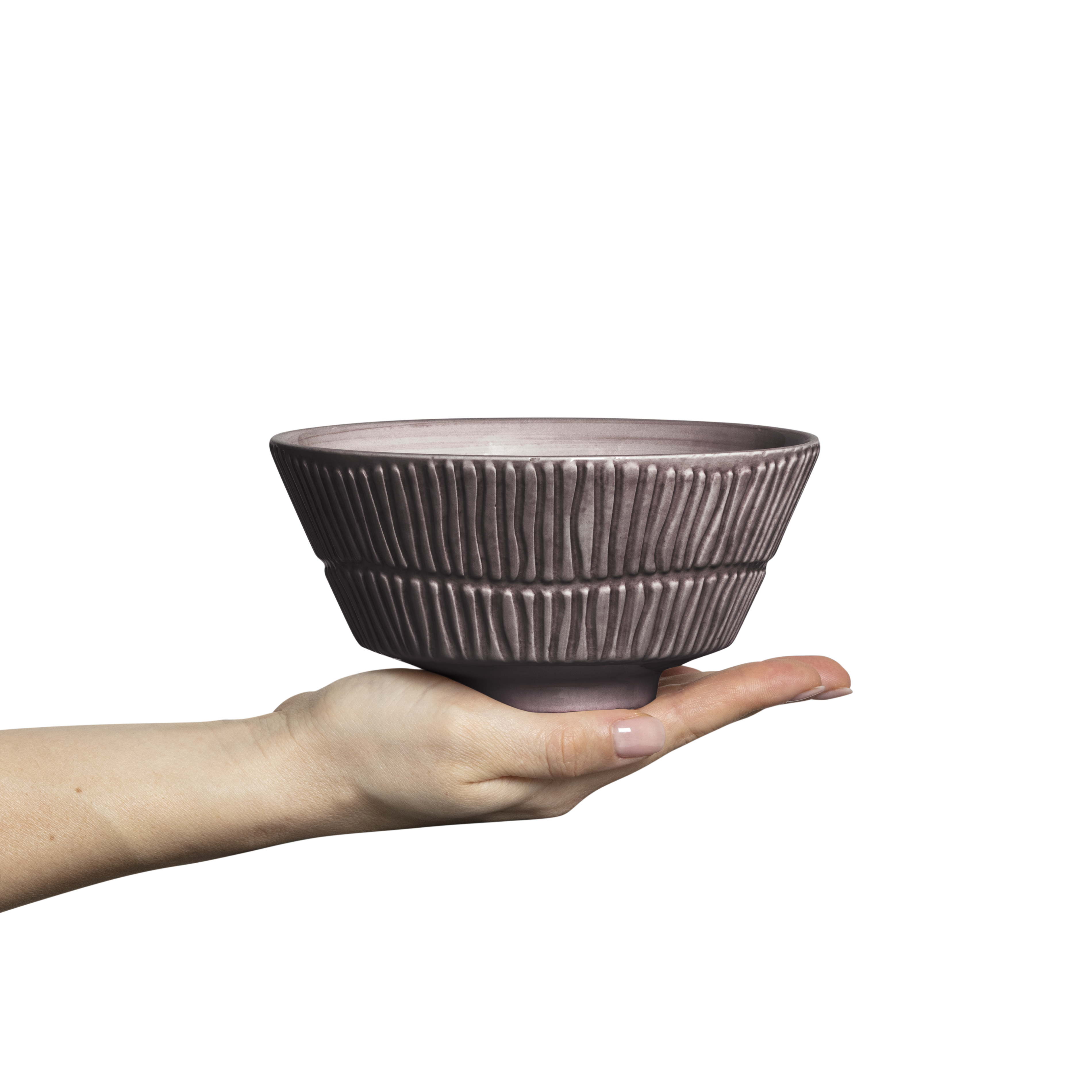 Hand holding a textured ceramic bowl against a white background