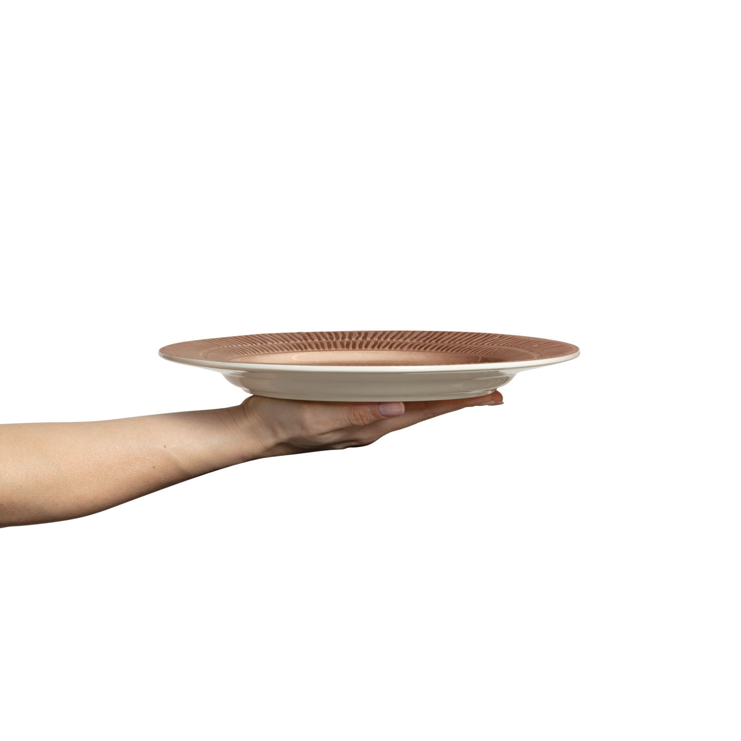 Hand holding a ceramic plate with a textured surface on a white background