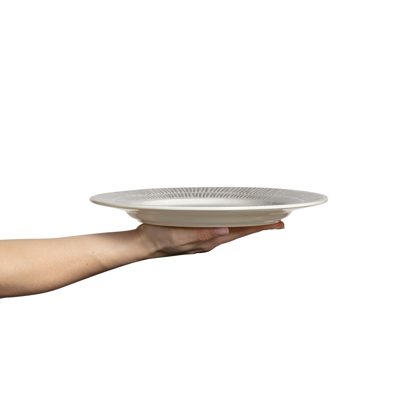 Hand holding a white ceramic plate with decorative patterns on a white background