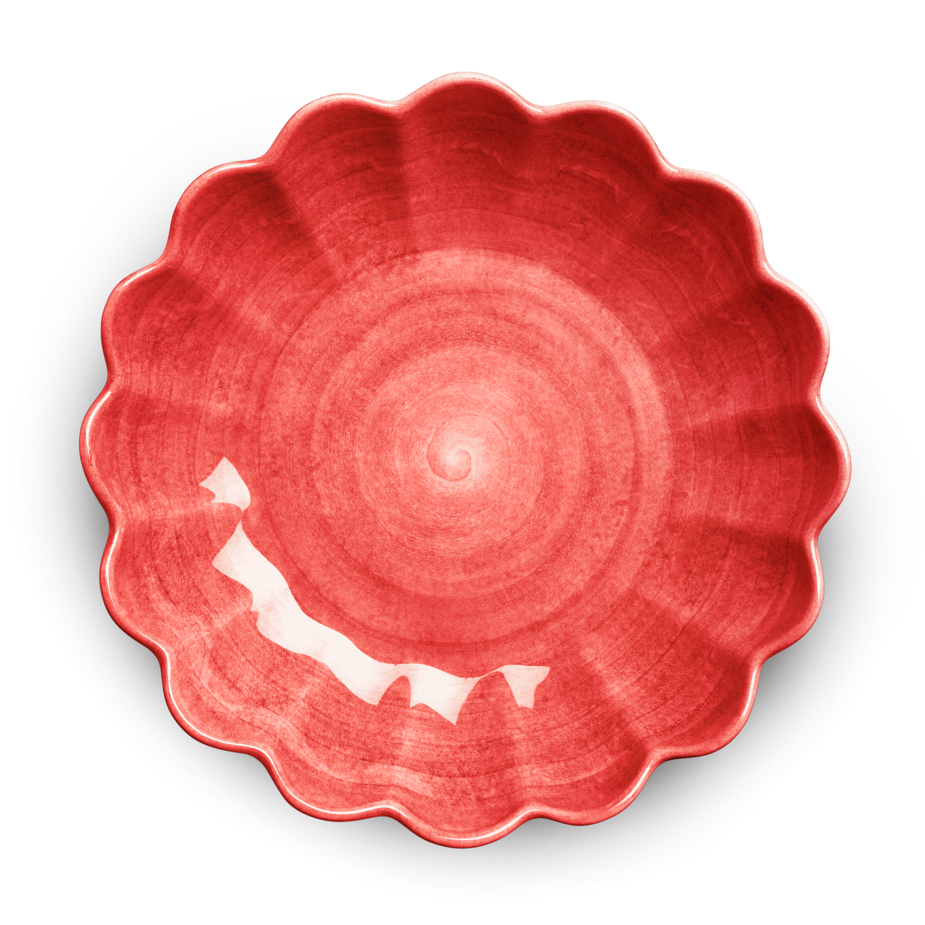 Red ceramic plate with scalloped edge on a white background