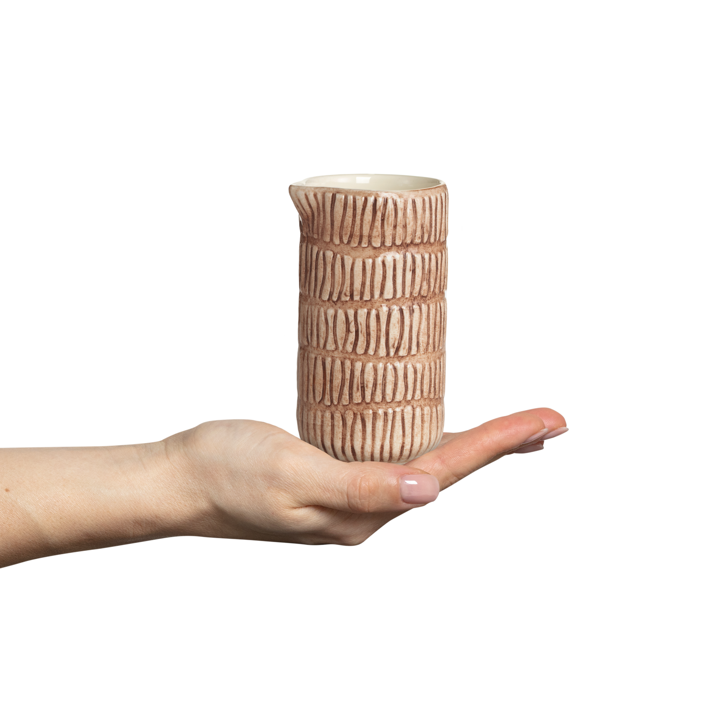 Hand holding a textured ceramic vase against a white background