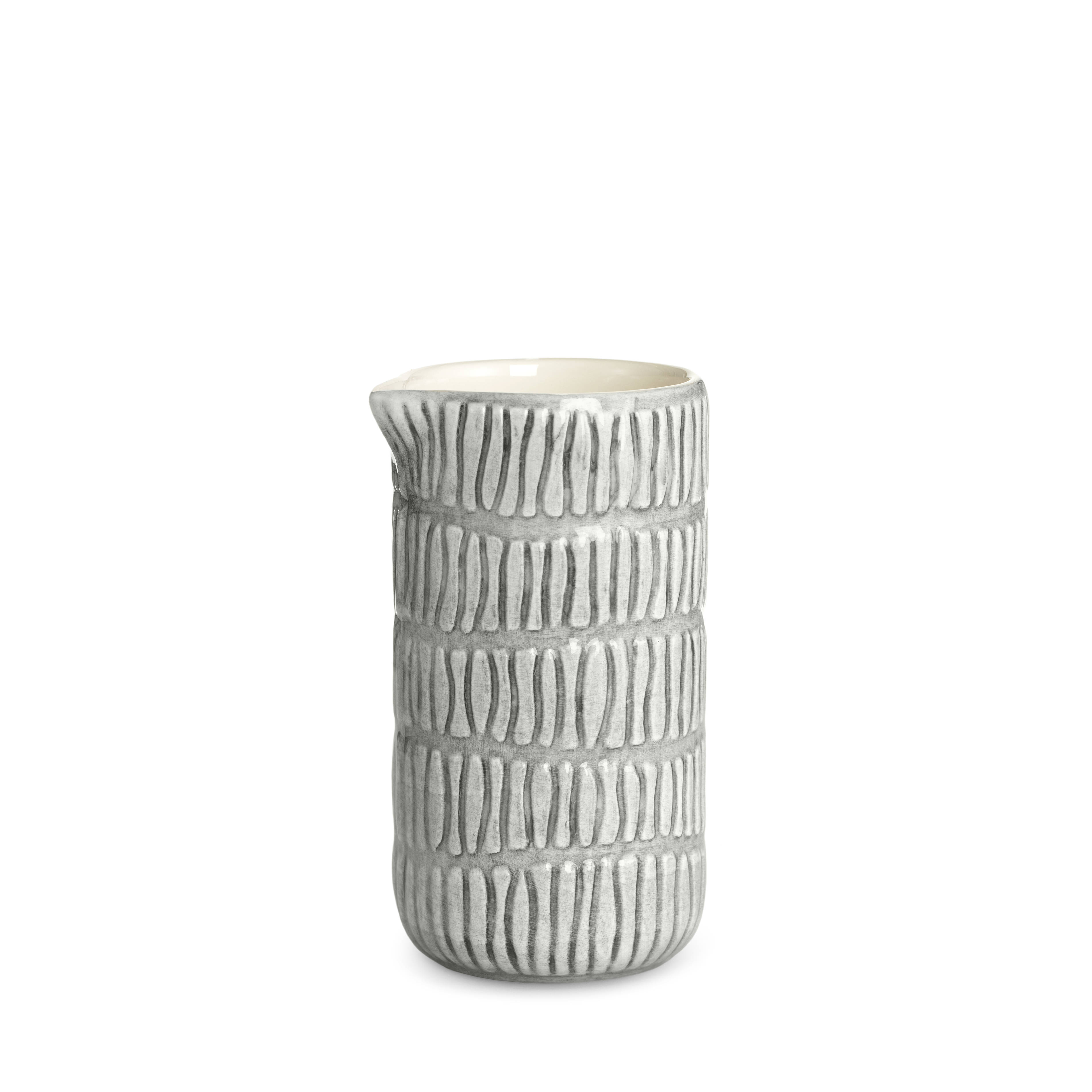 Ceramic jug with textured design on a white background