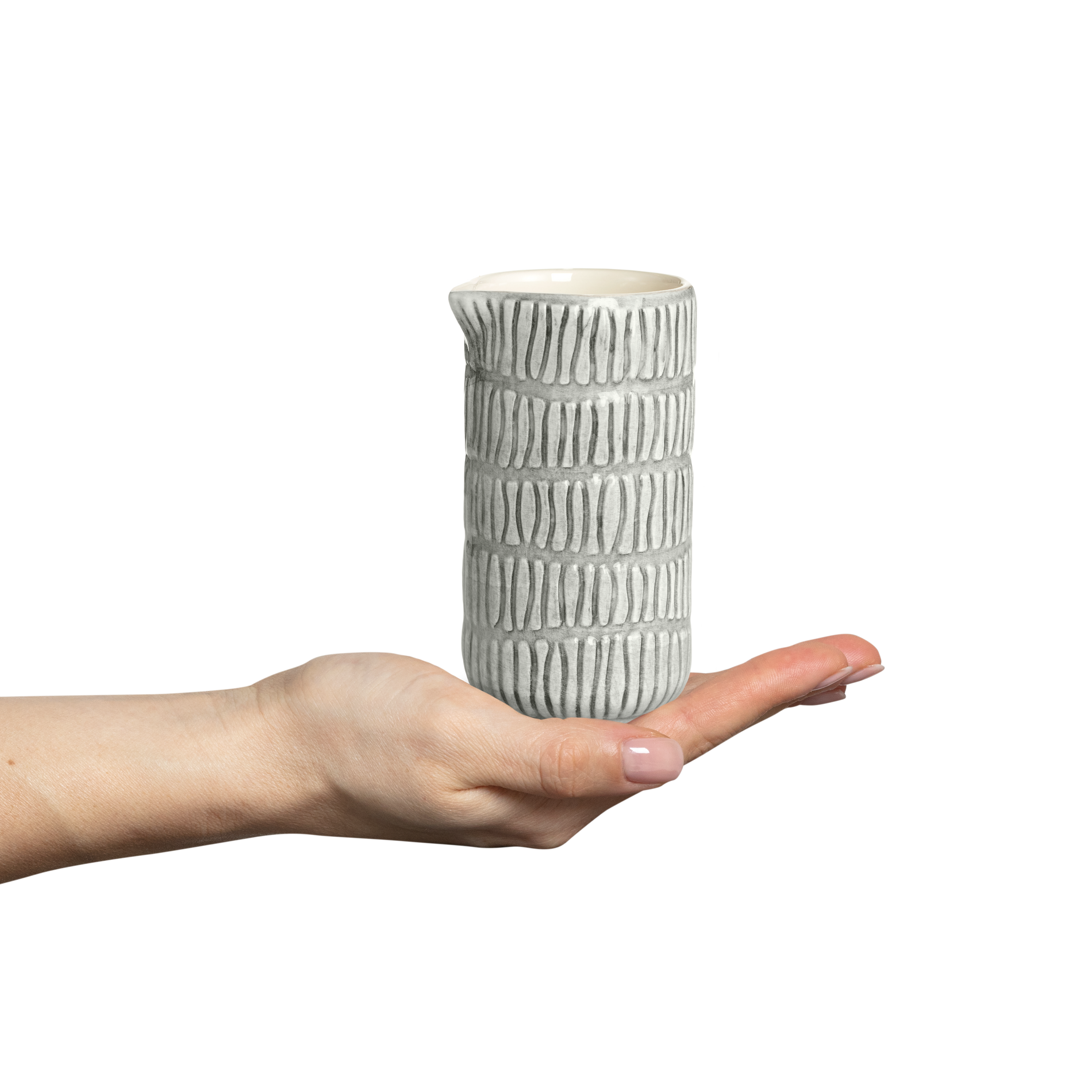 Hand holding a textured ceramic vase against a white background