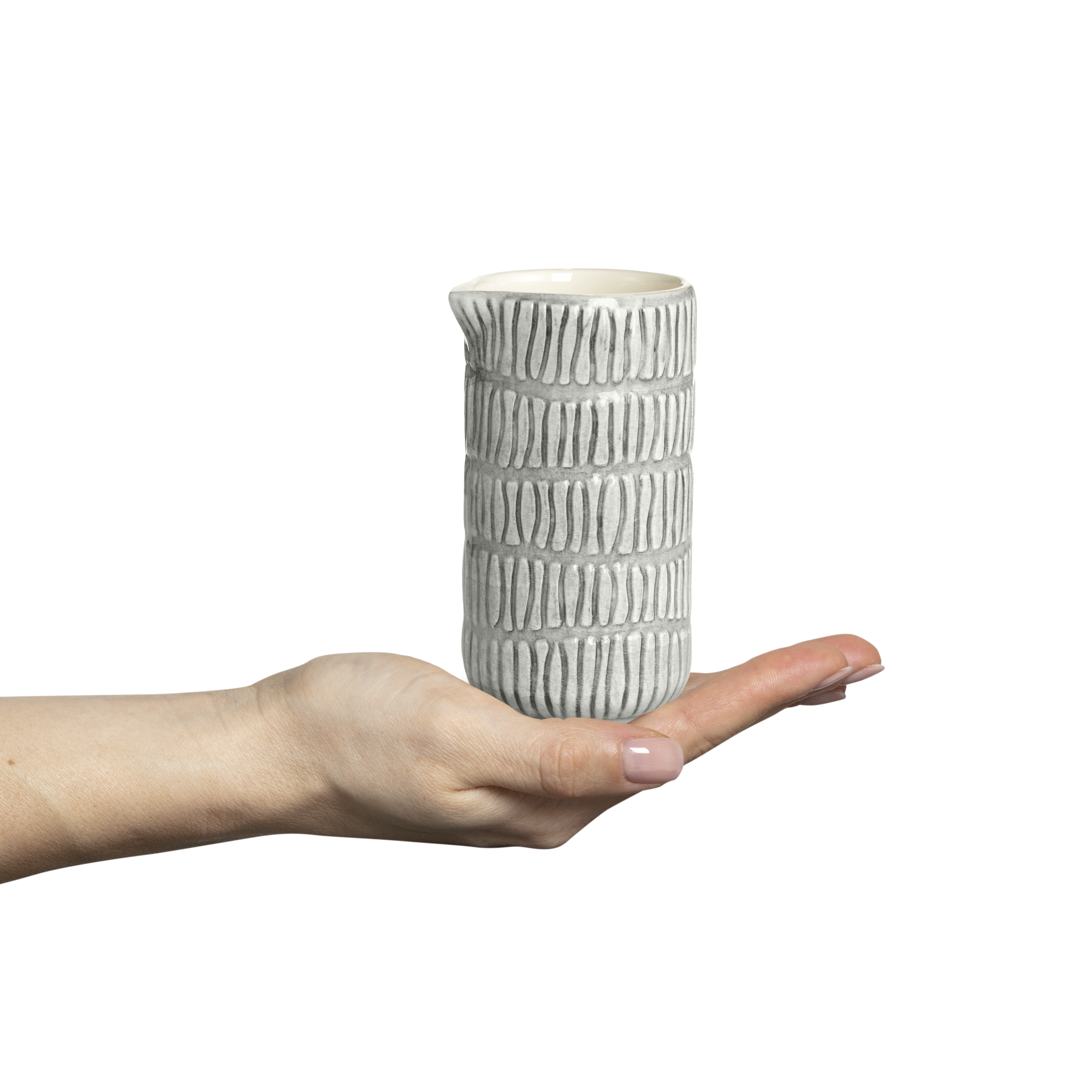 Hand holding a textured ceramic vase against a white background