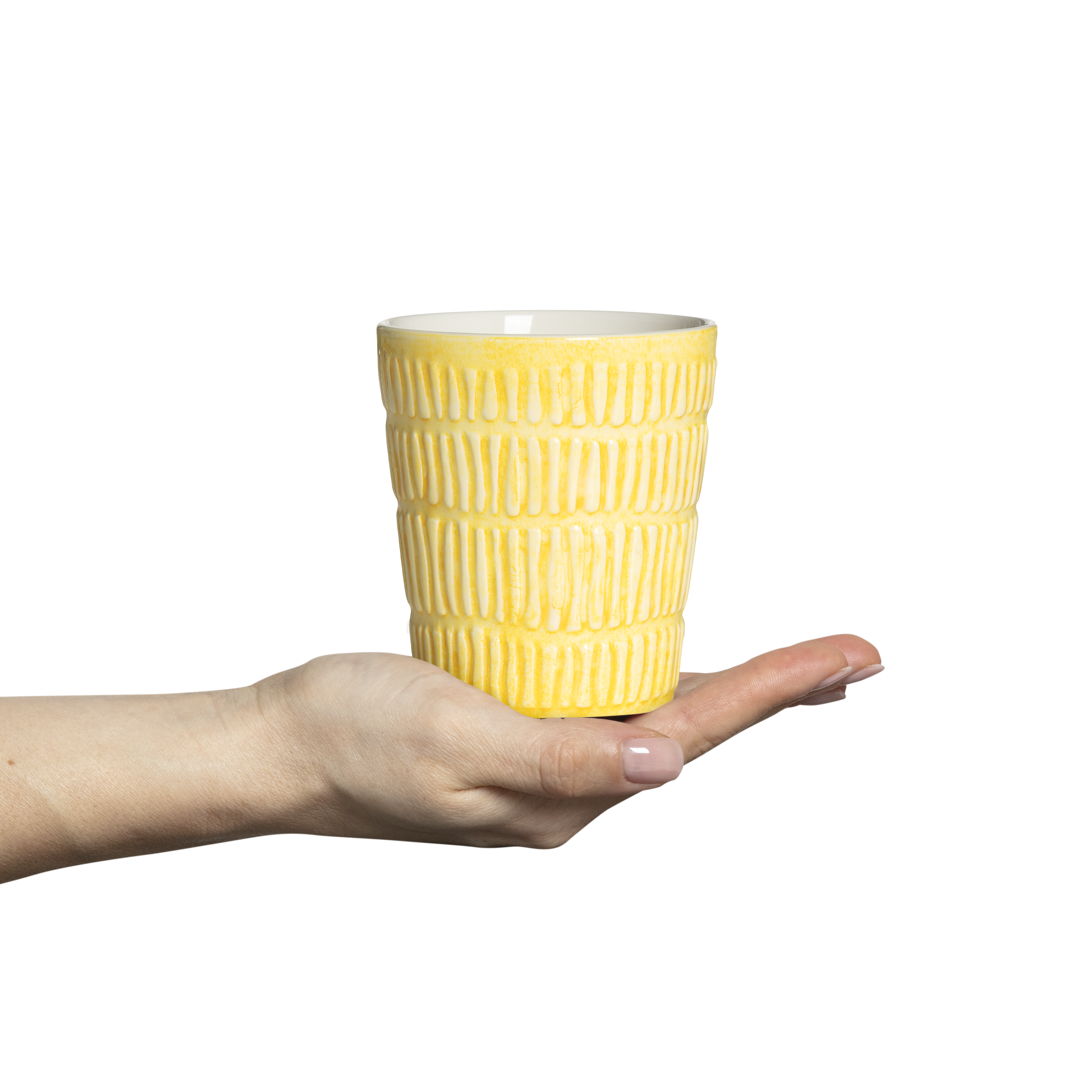 Yellow textured mug held in a hand against a white background