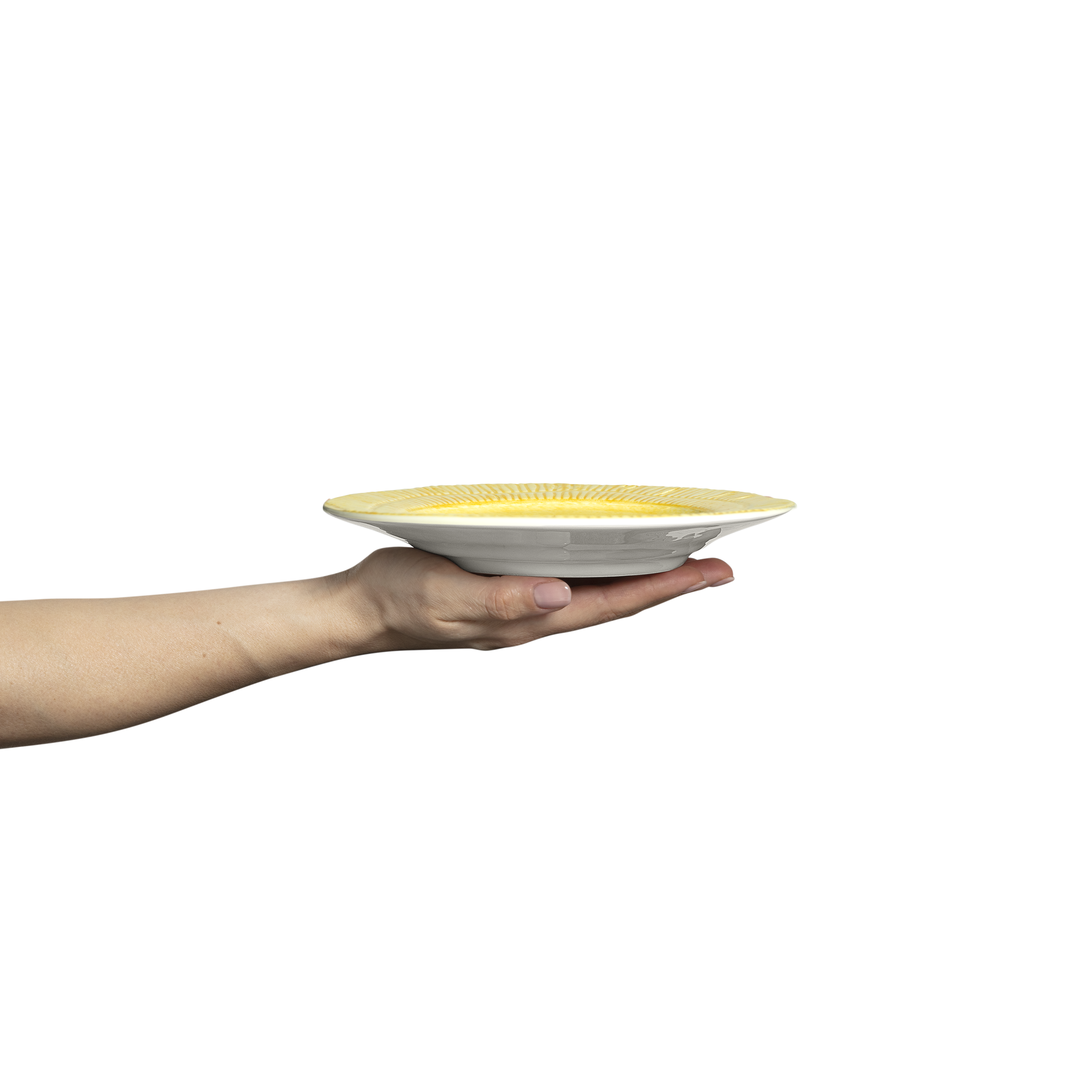 Hand holding a yellow and white ceramic plate against a white background