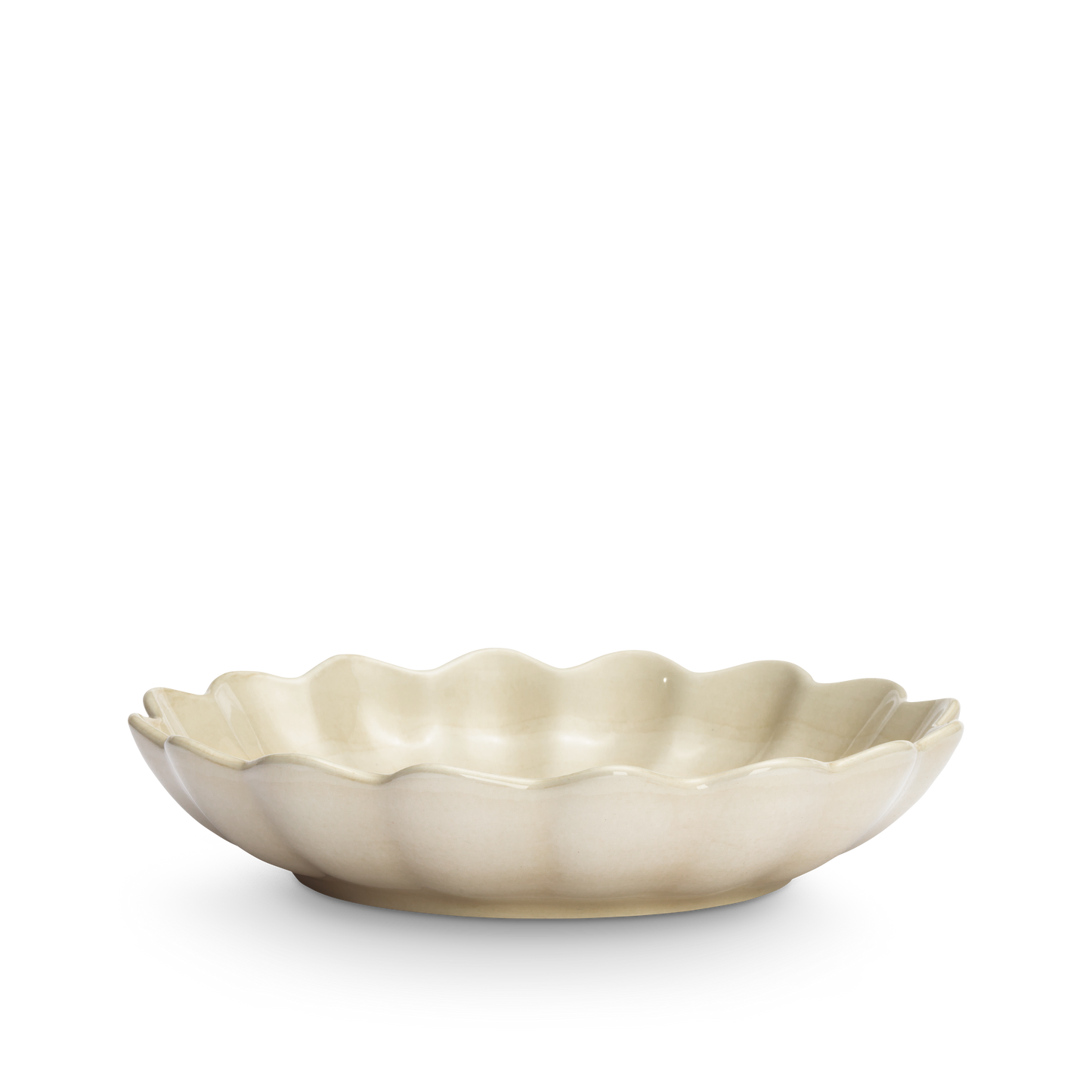 Beige ceramic bowl with scalloped edge on a white background