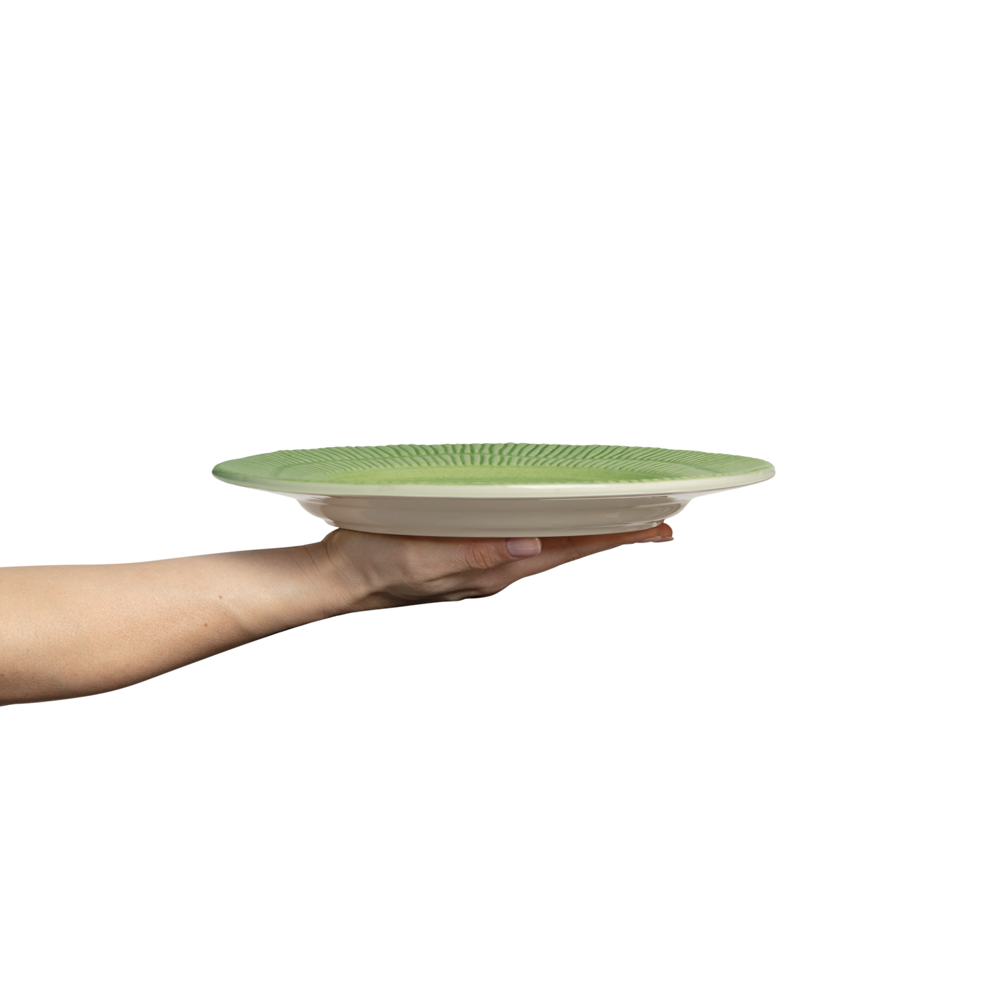 Hand holding a green ceramic plate against a white background