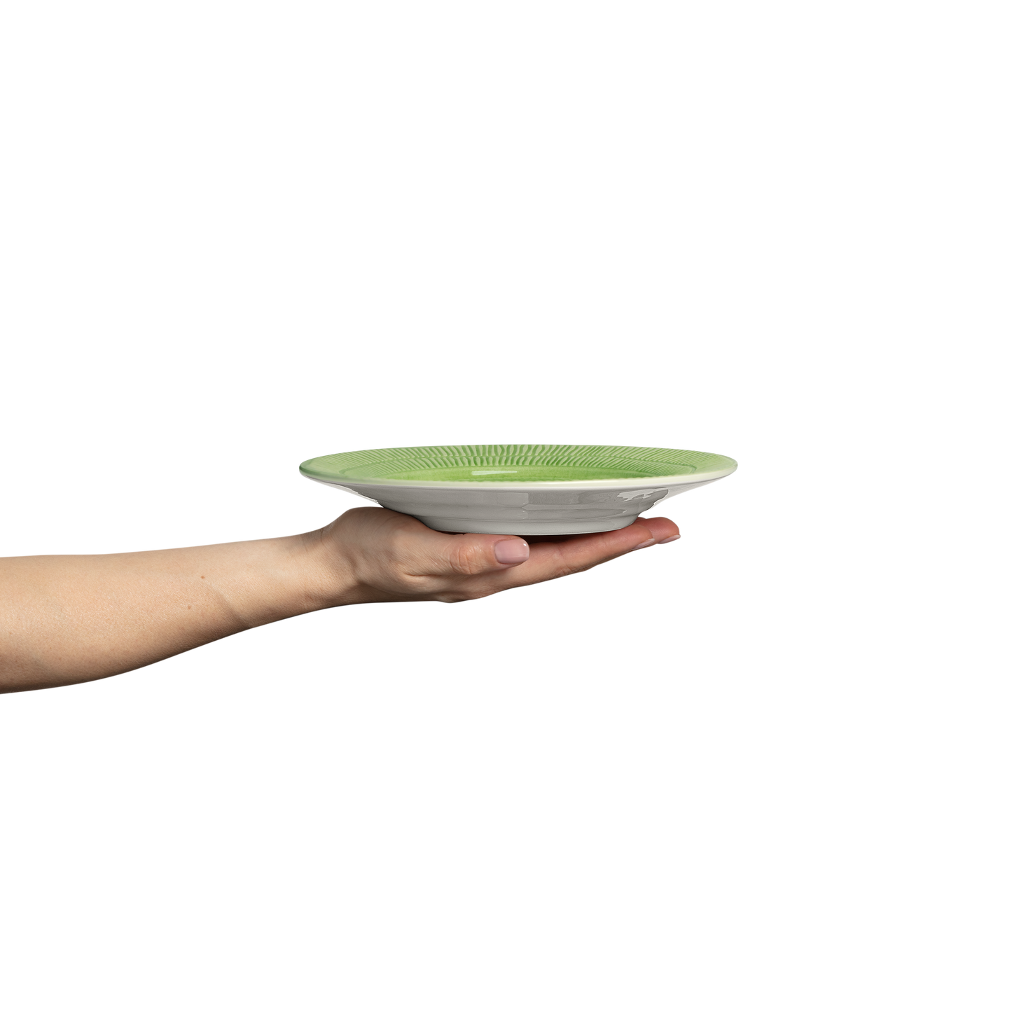 Hand holding a green plate on a white background