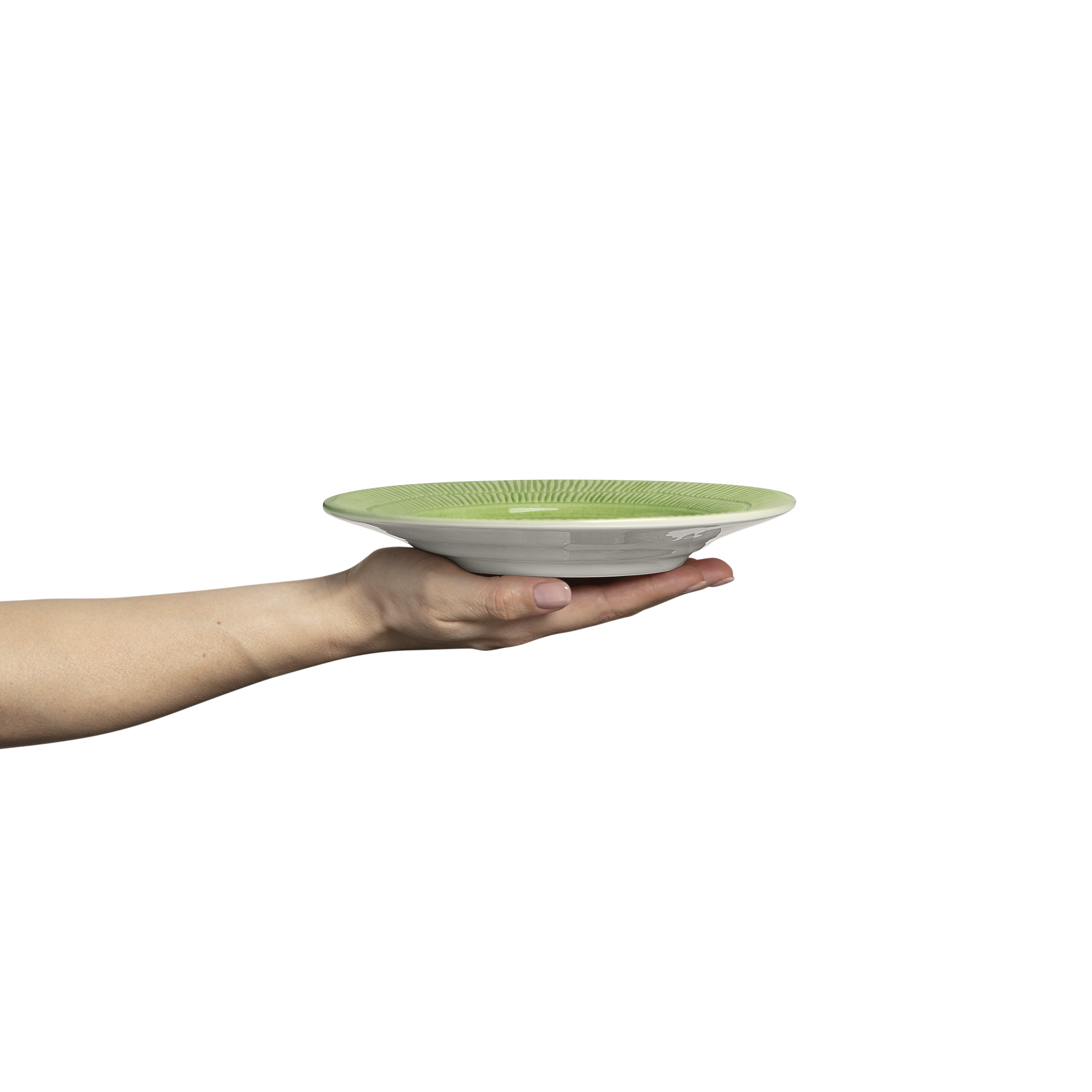 Hand holding a green plate on a white background