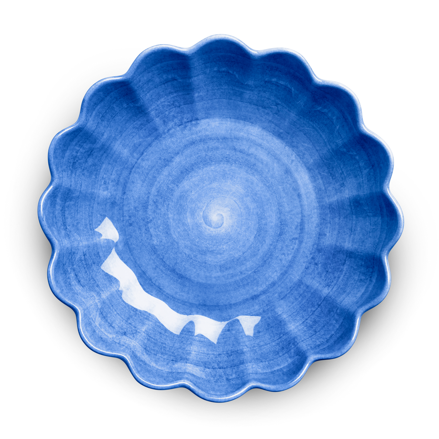 Blue ceramic plate with scalloped edge on a white background