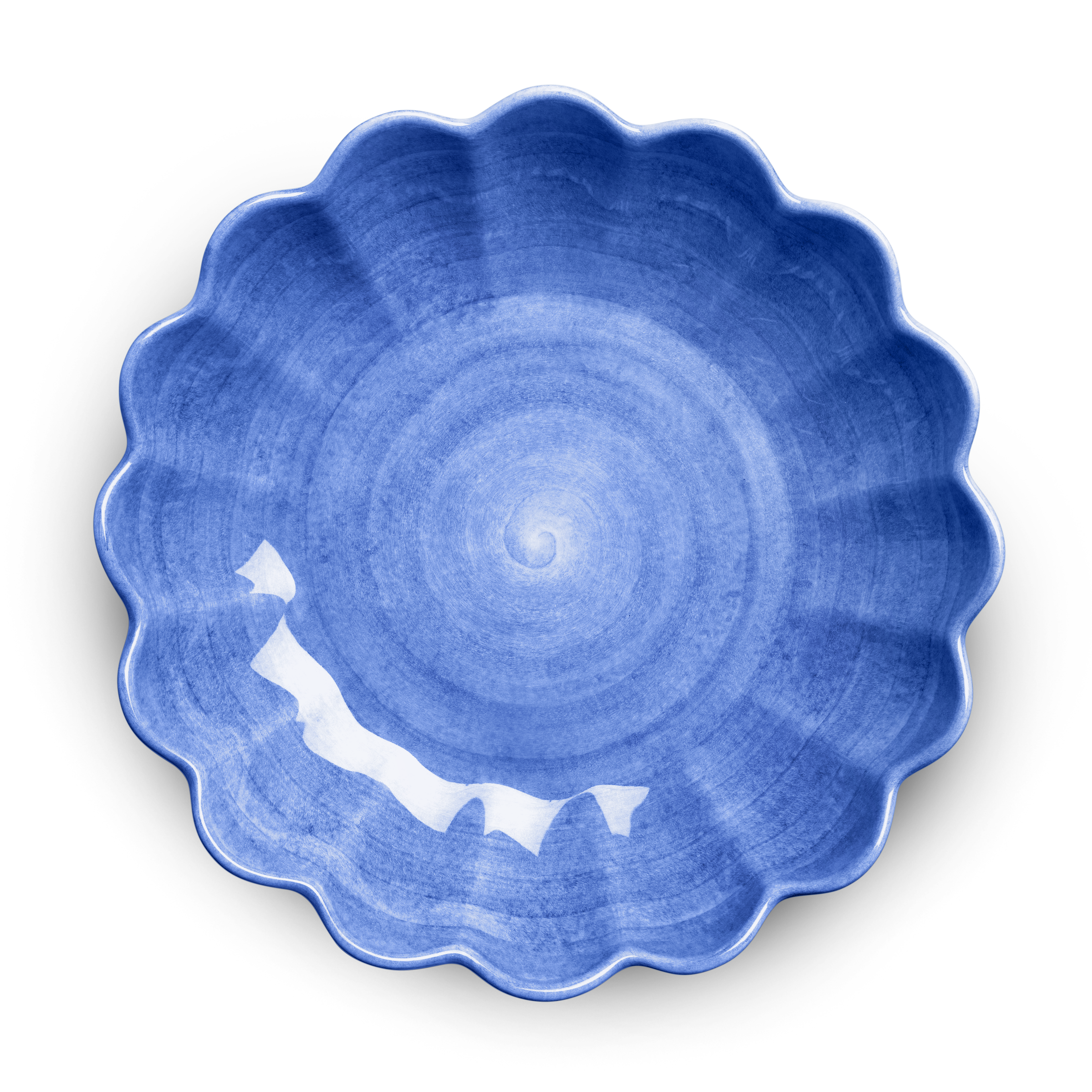 Blue ceramic plate with scalloped edge on a white background