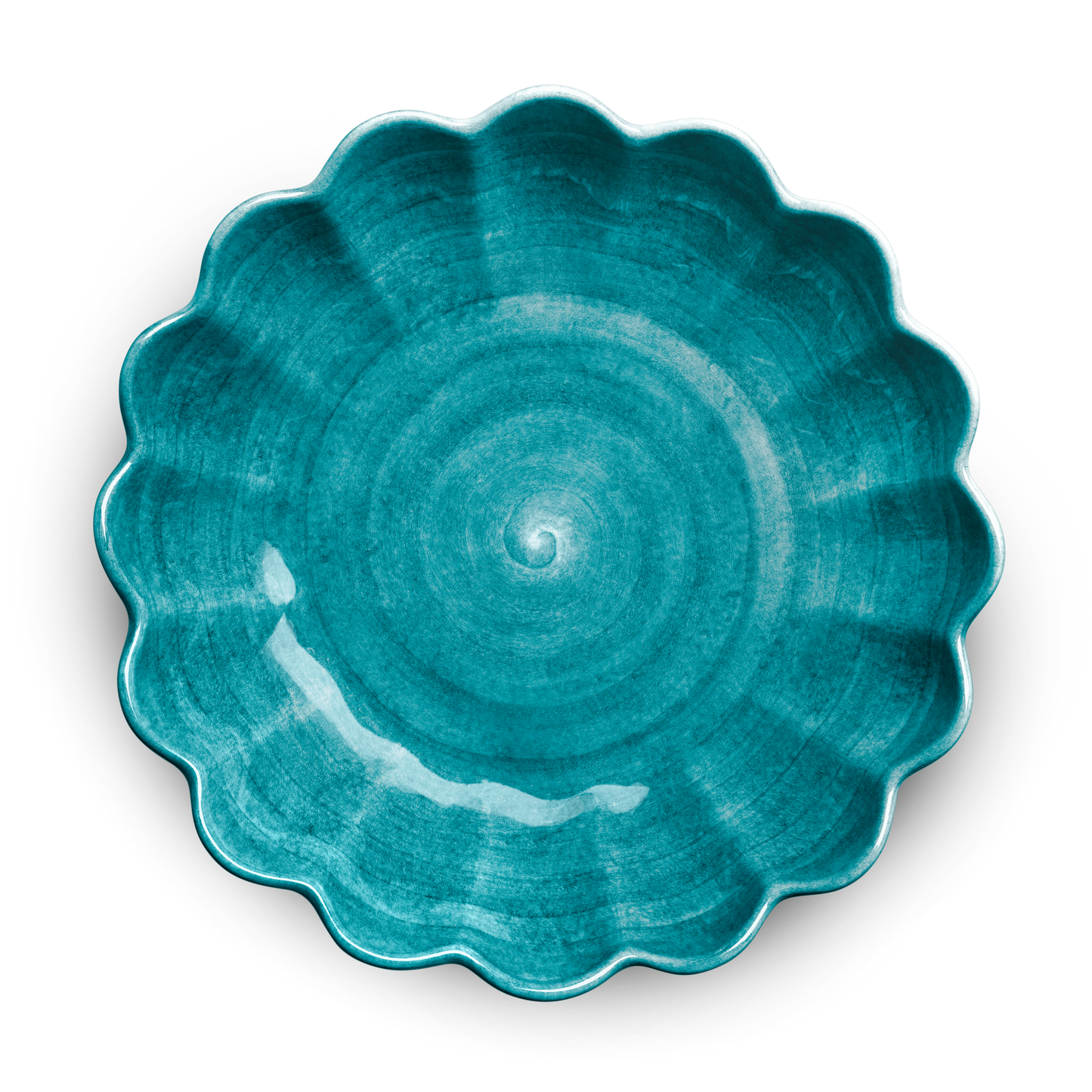 Teal ceramic plate with scalloped edge on a white background