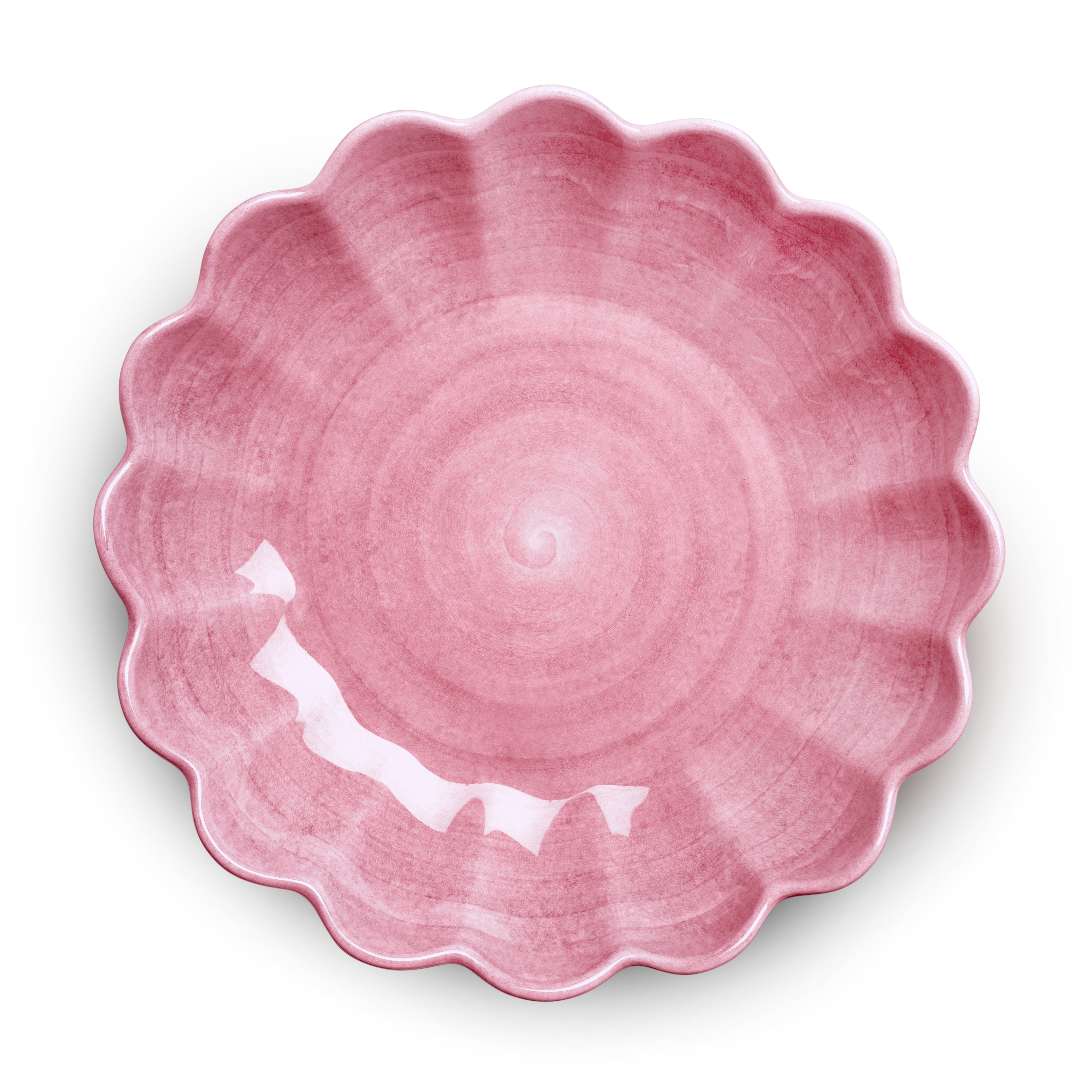 Pink ceramic bowl with scalloped edge on a white background