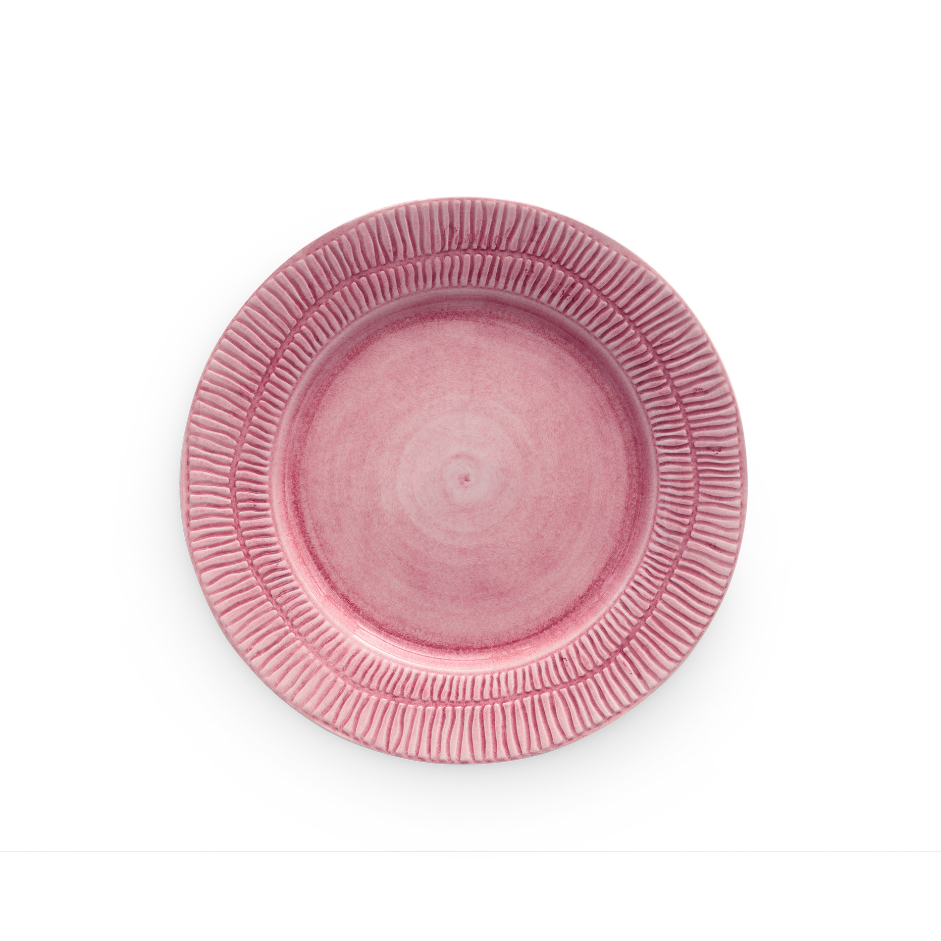 Pink ceramic plate with textured rim on a white background